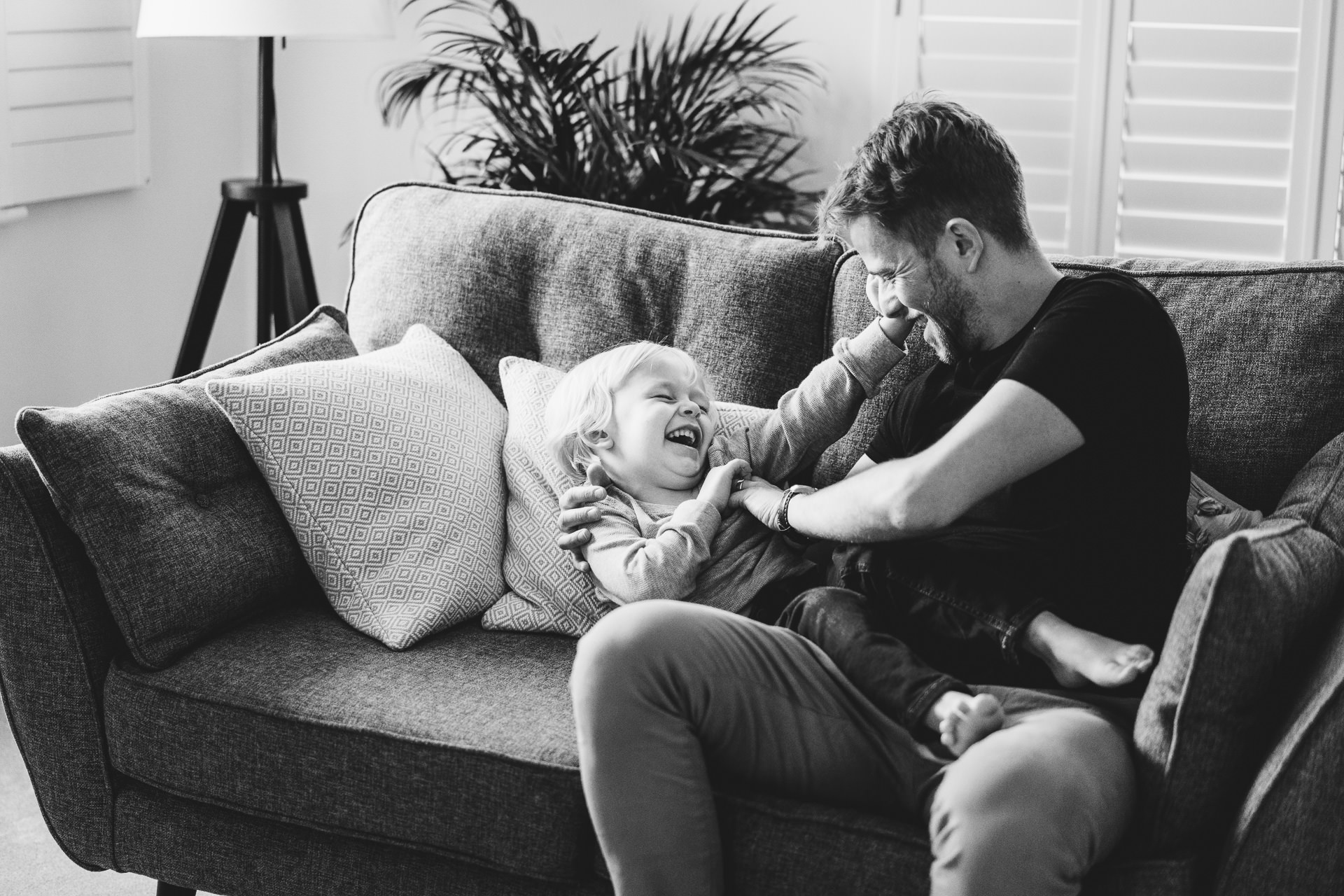 Relaxed Dorset family photography, a Dad and son playing on a sofa together
