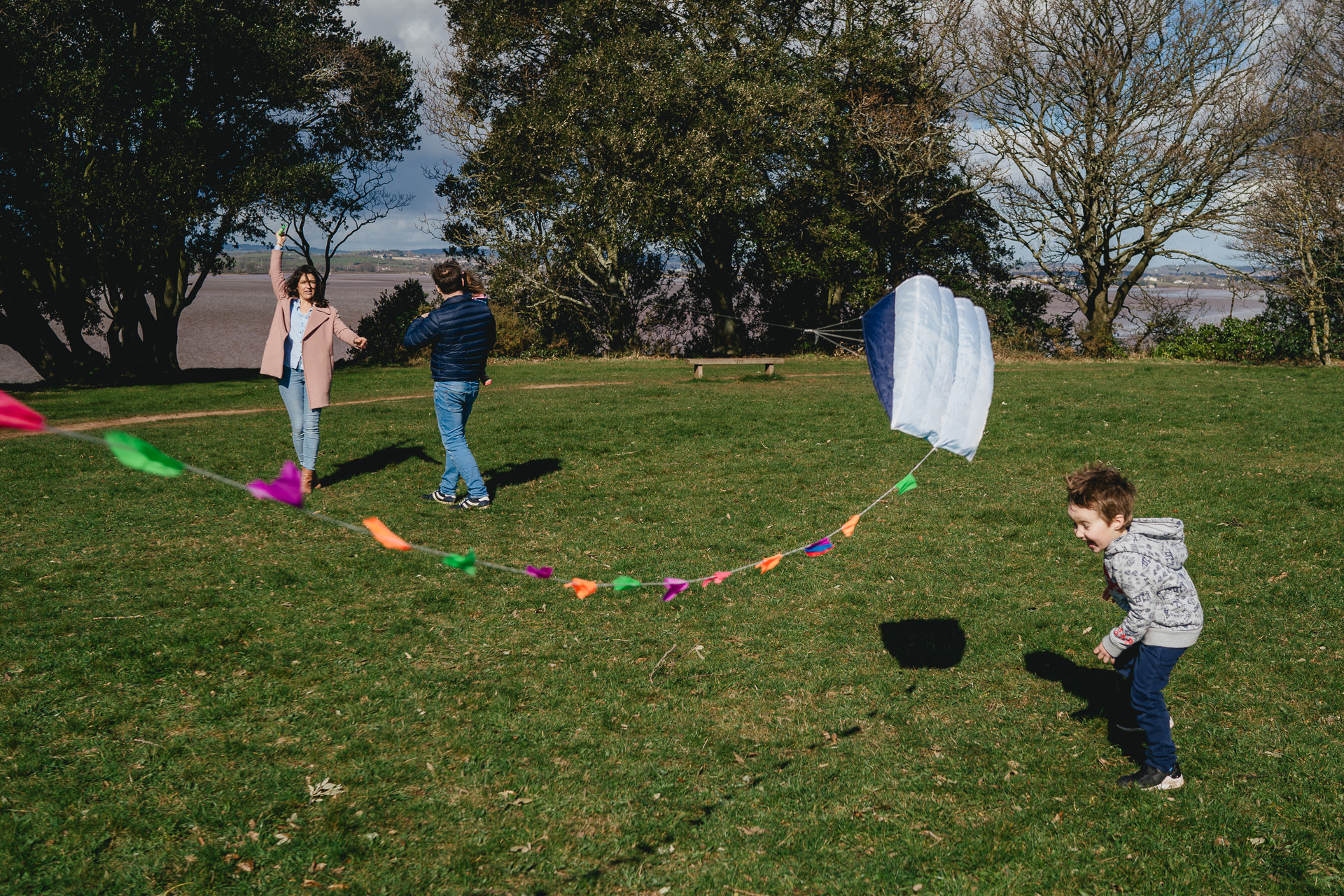 A family playing with a kite together
