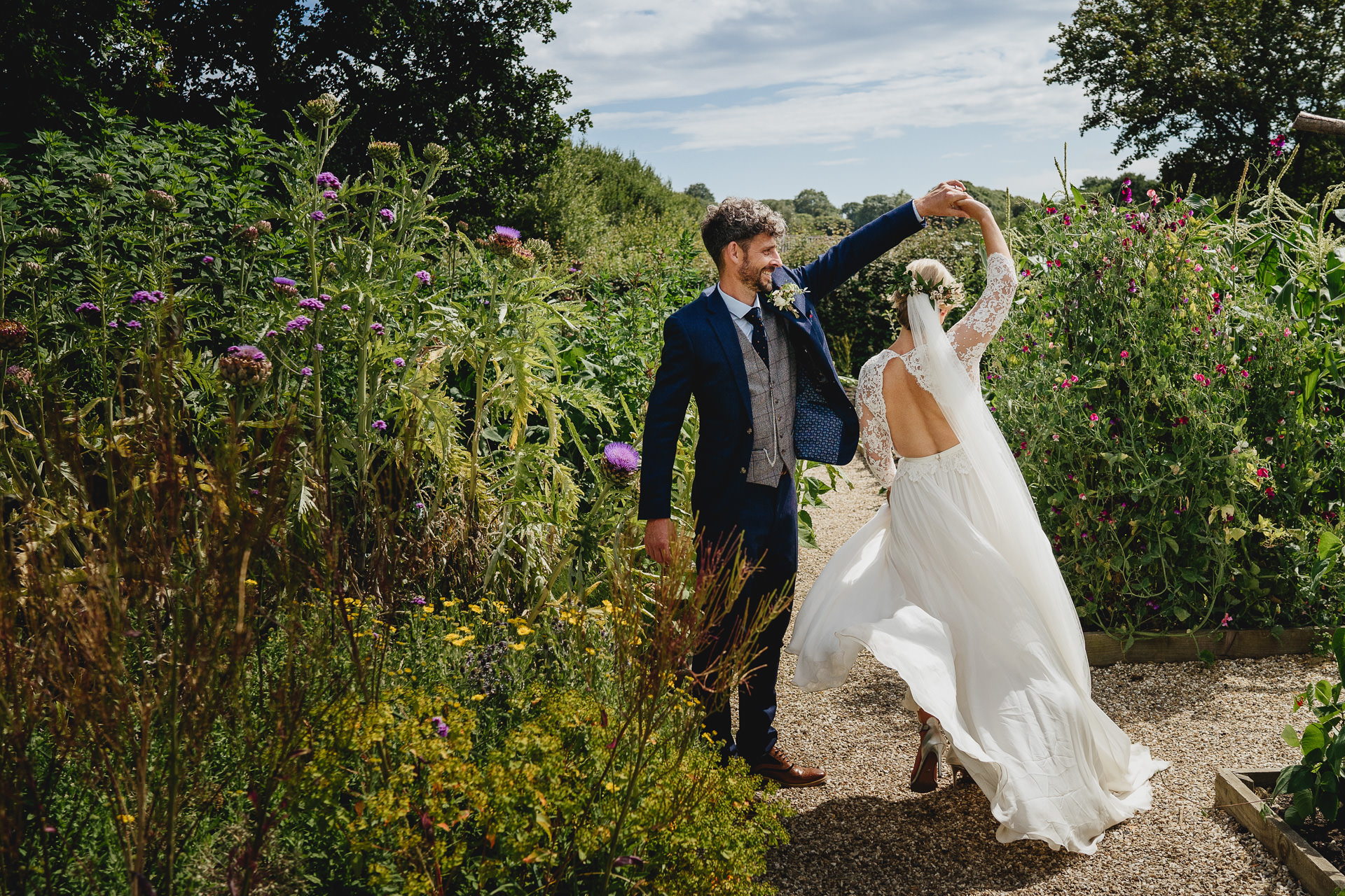 A bride and groom in the kitchen garden at River Cottage