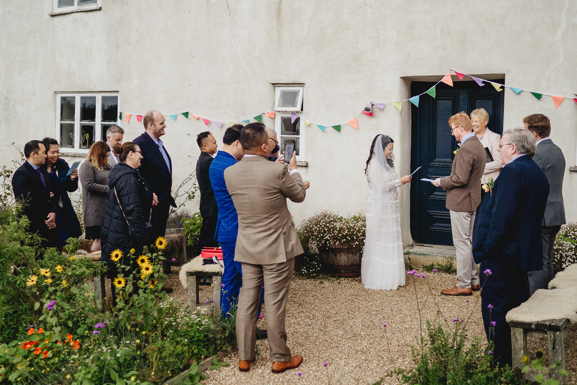 An autumn outdoor wedding ceremony, with the bride and groom reading vows