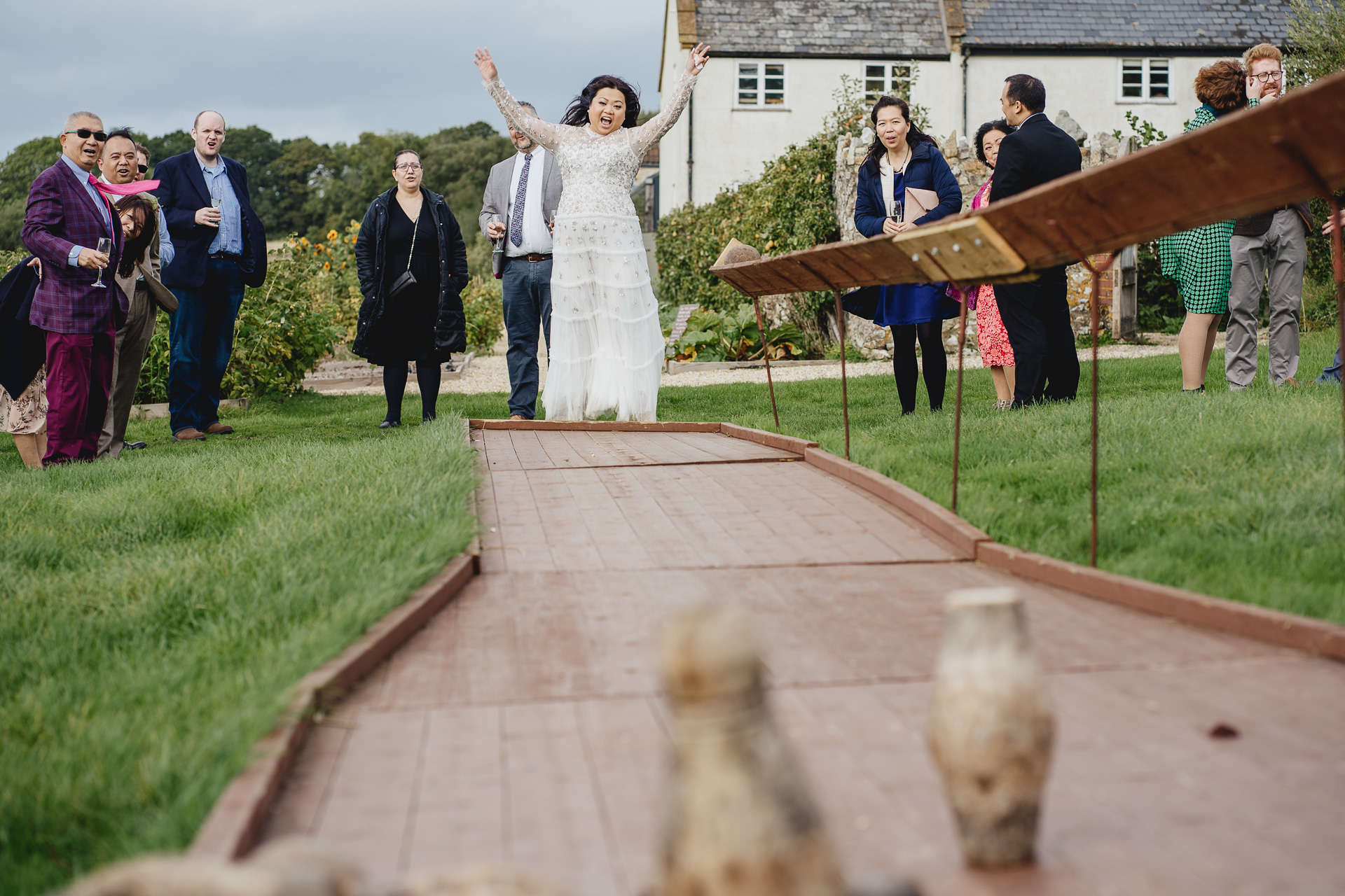 bride jumping with joy playing skittles