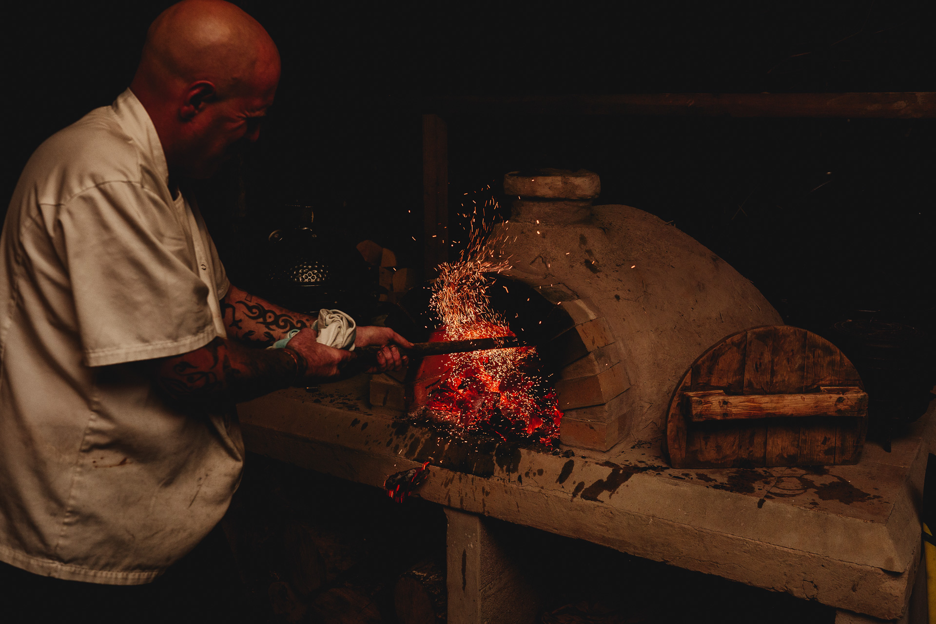 a man making fire in a pizza oven