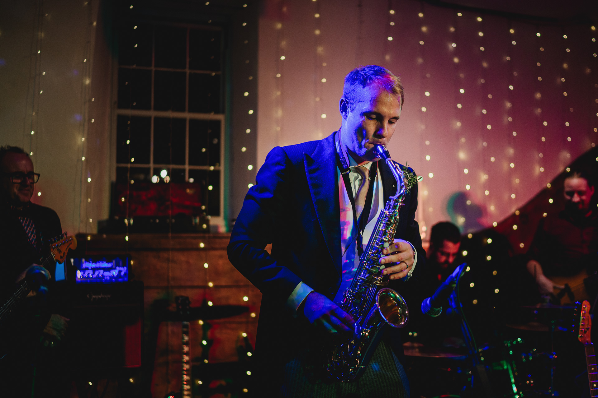 The groom, playing the saxophone