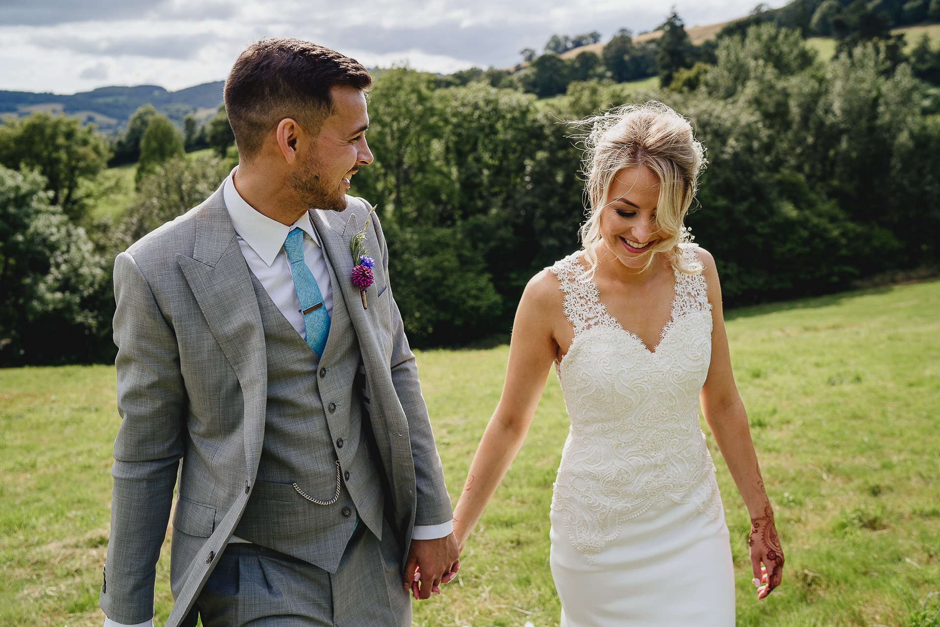 Bride and groom walking in Devon hills together
