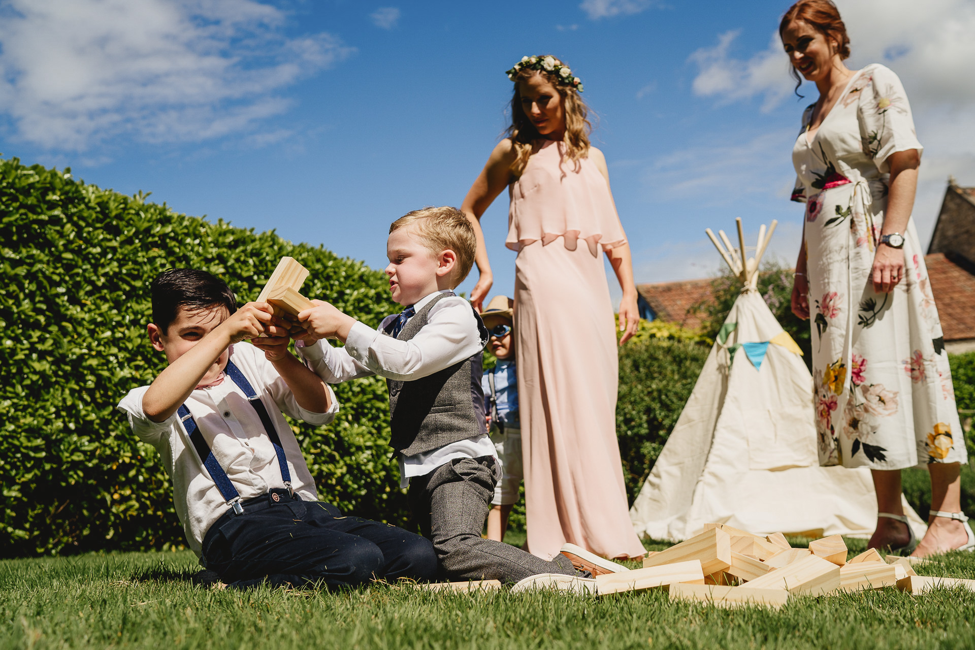 Children playing outside a tipi