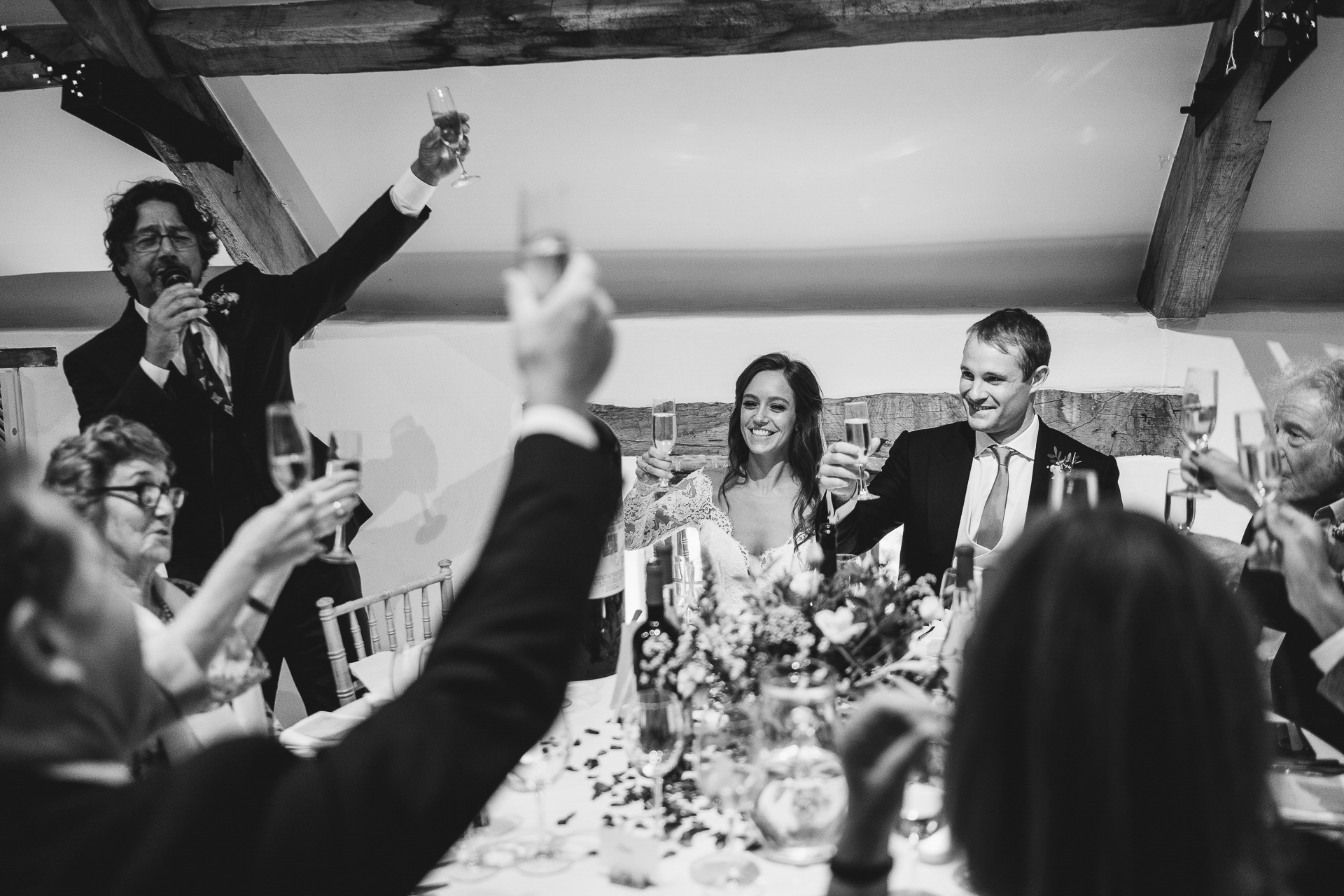 Top table raising wedding toasts