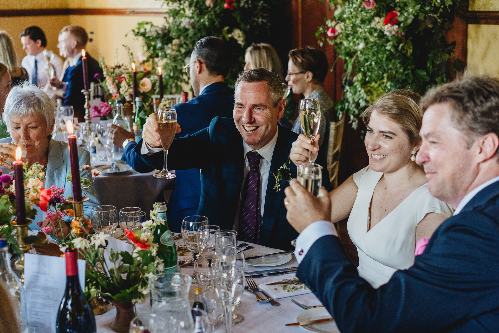 Bride and groom raising glasses during wedding toasts