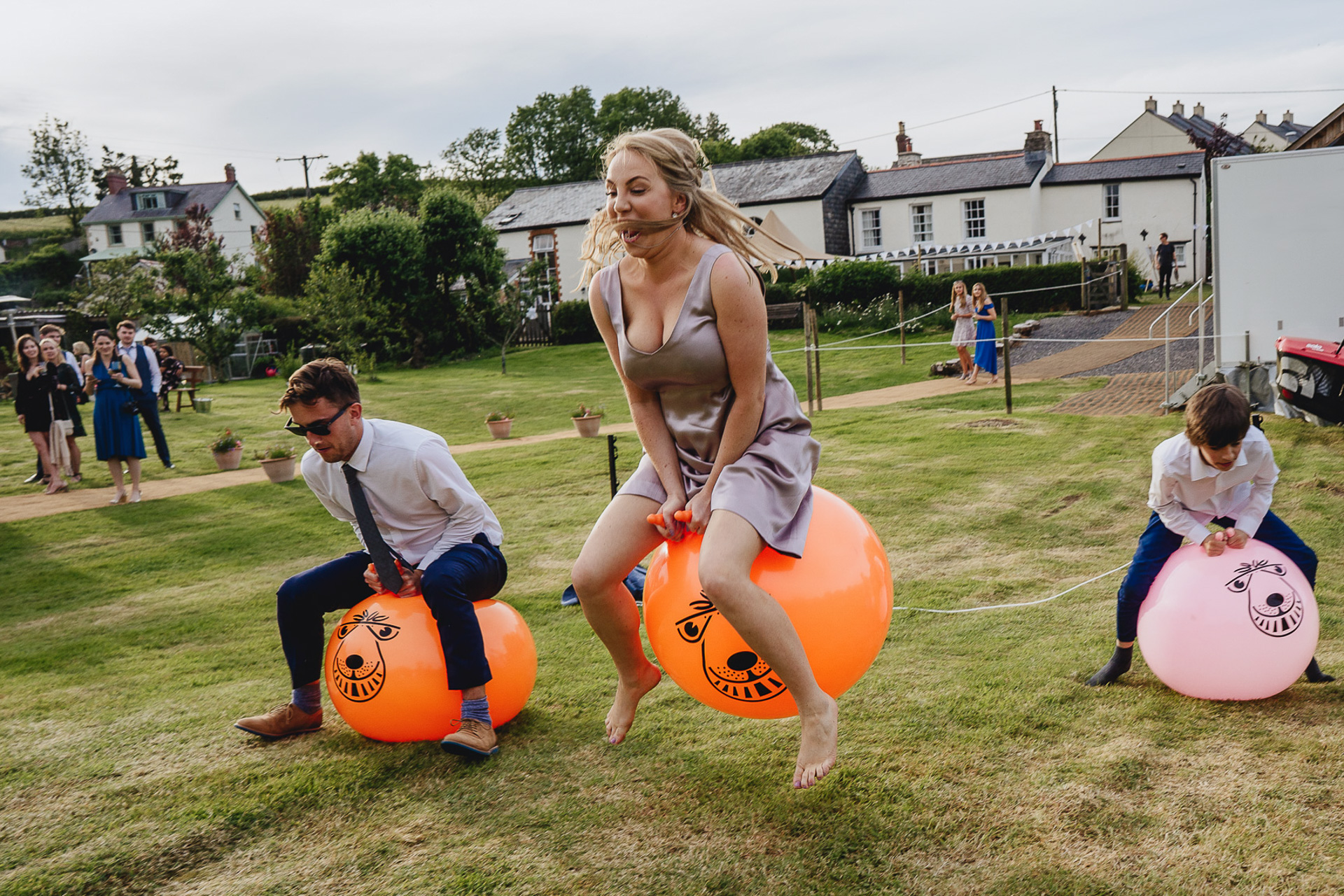 Bridesmaid and wedding guests on space hoppers