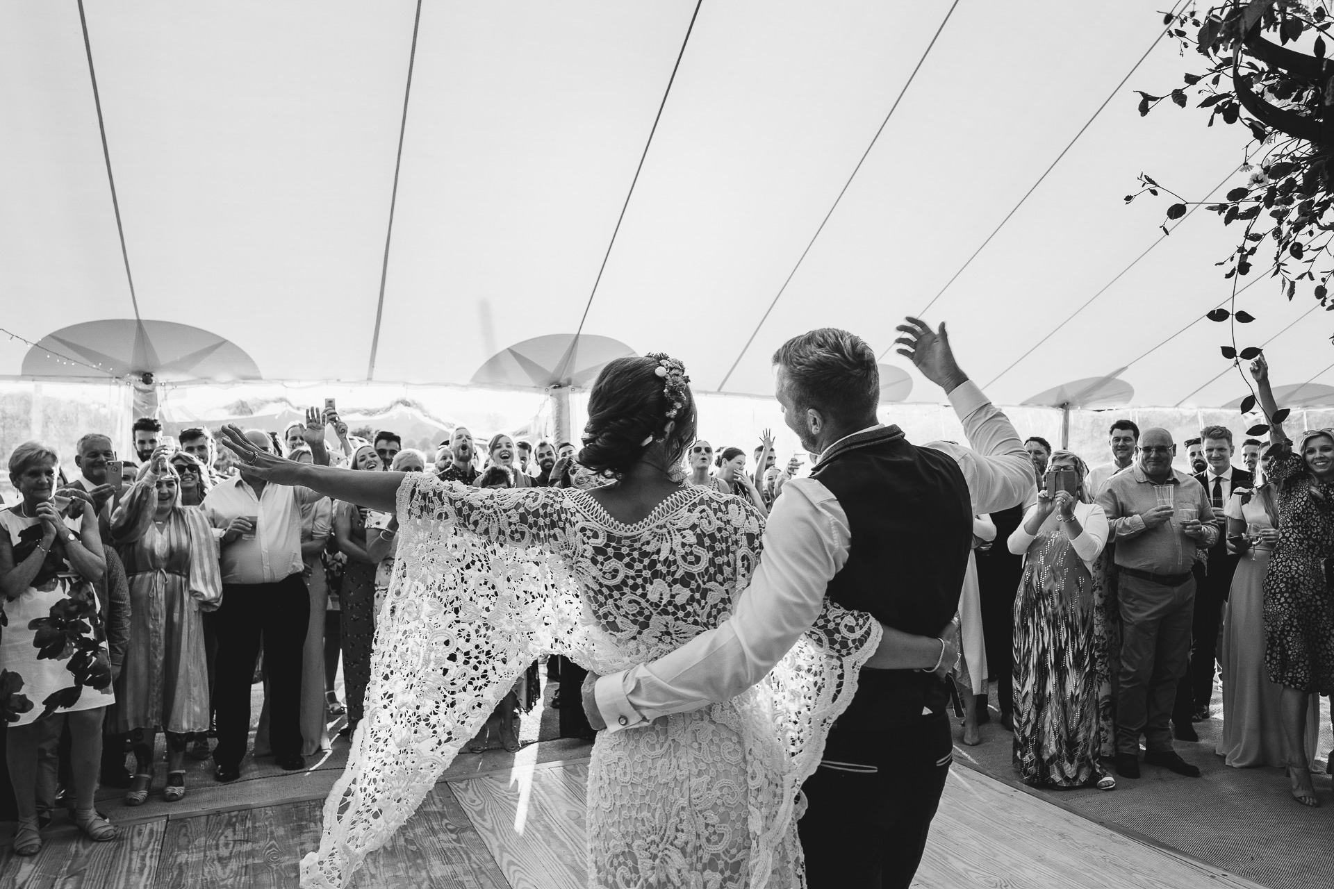 Bride and groom doing first dance in a marquee