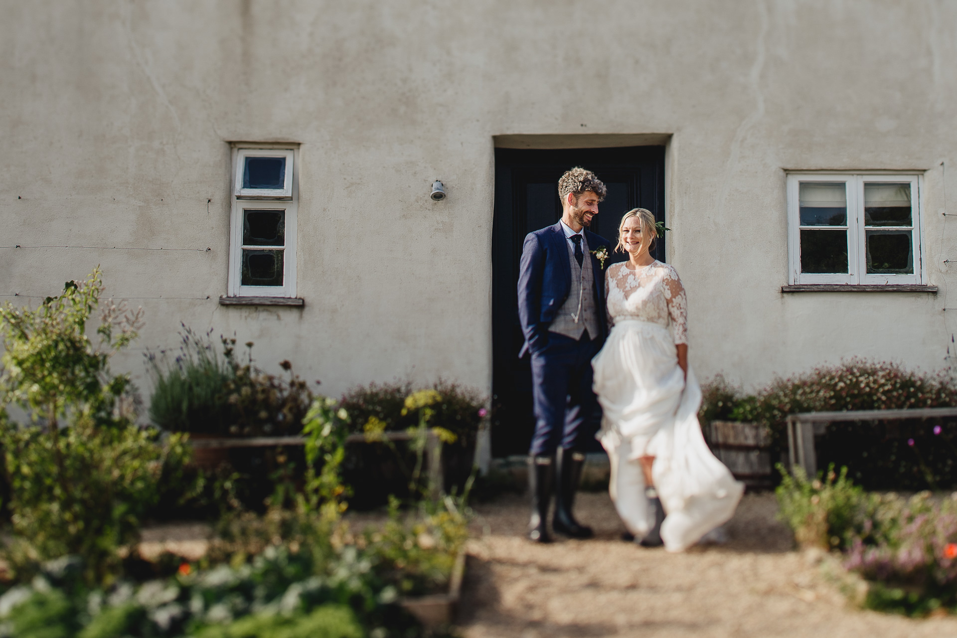 Bride and groom in wellies outside River Cottage farmhouse