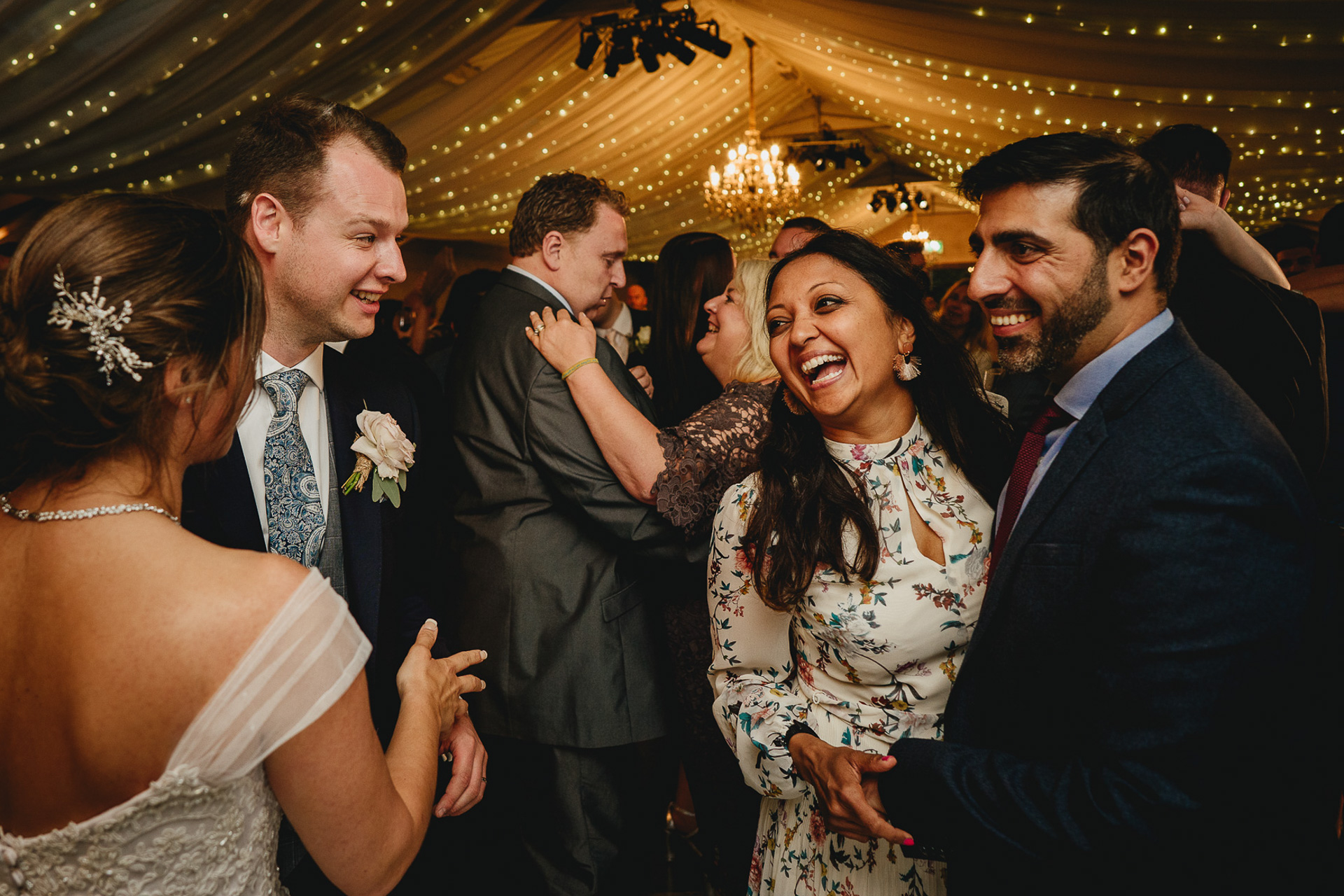 Wedding guests laughing on the dance floor