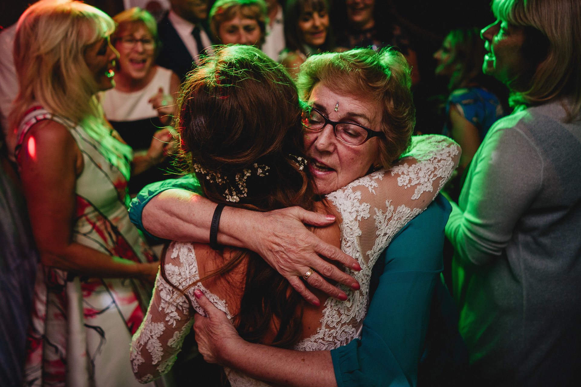 Bride having cuddle with grandmother