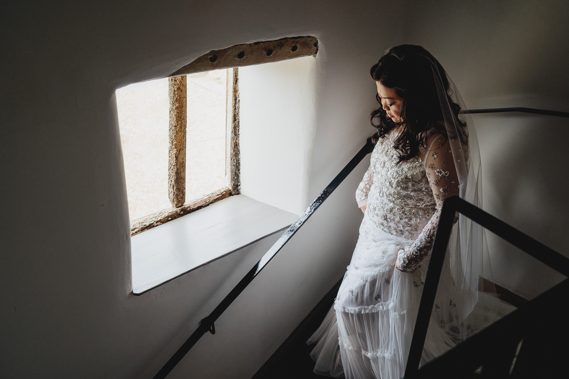 Bride walking down a staircase at River Cottage