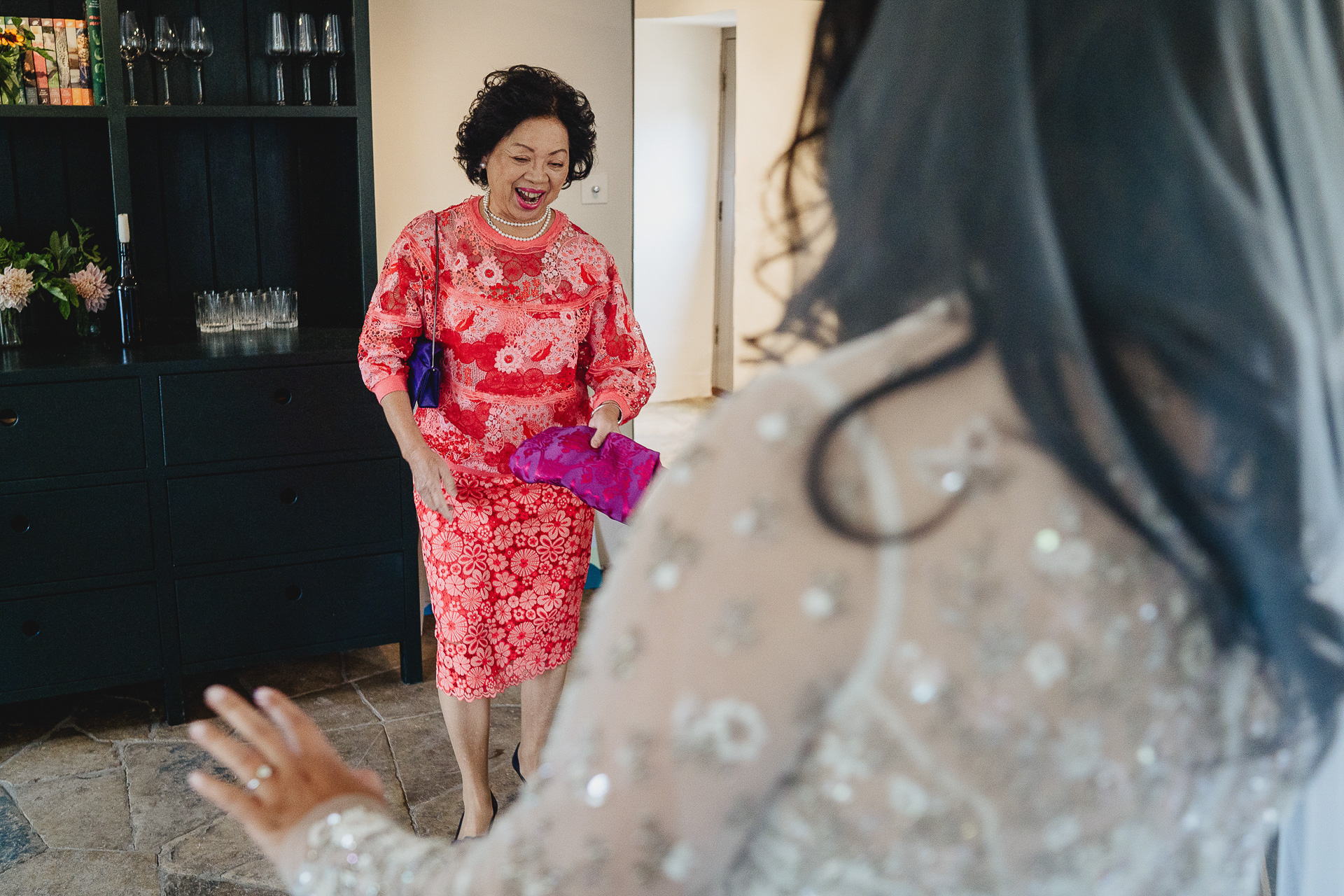 Mother of the bride smiling at bride