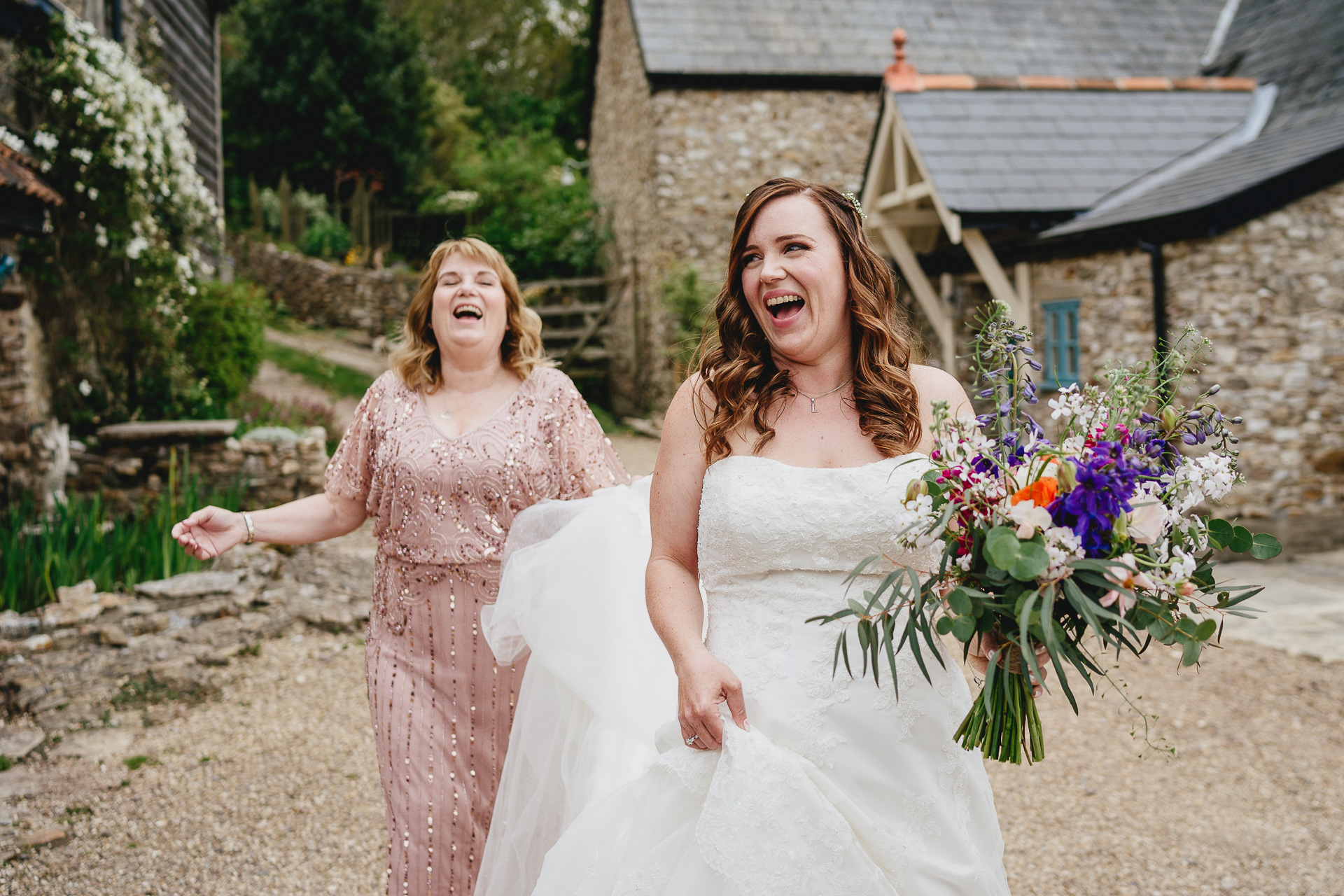 Bride and mother laughing together