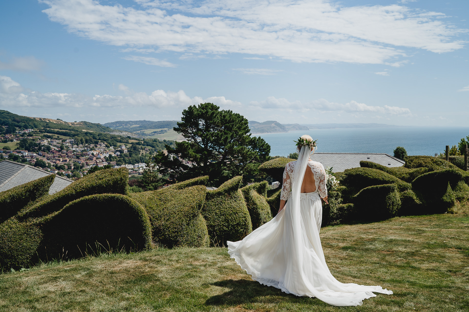 Bride looking at the sea over Lyme Regis bay
