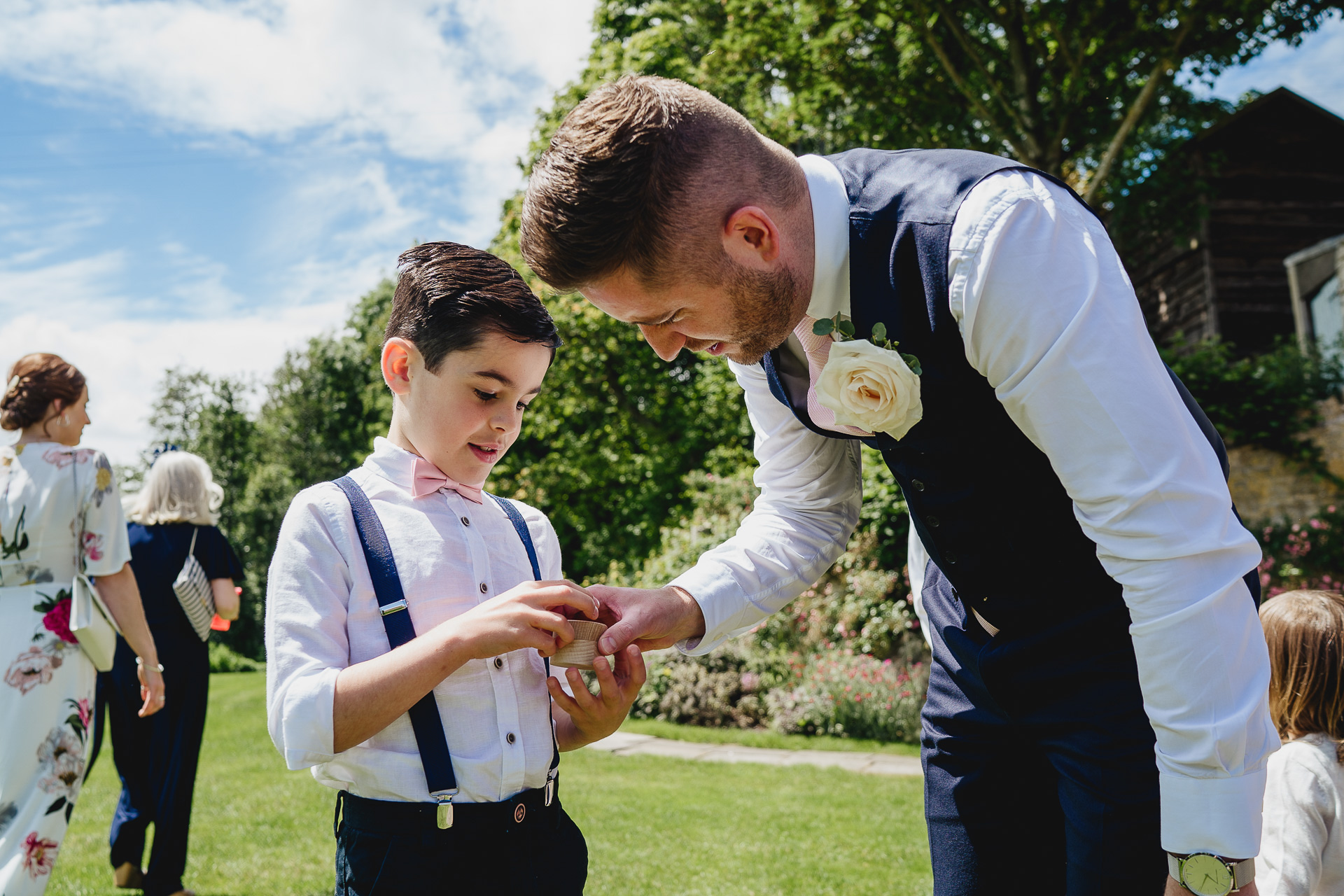 Best man and page boy holding wedding rings
