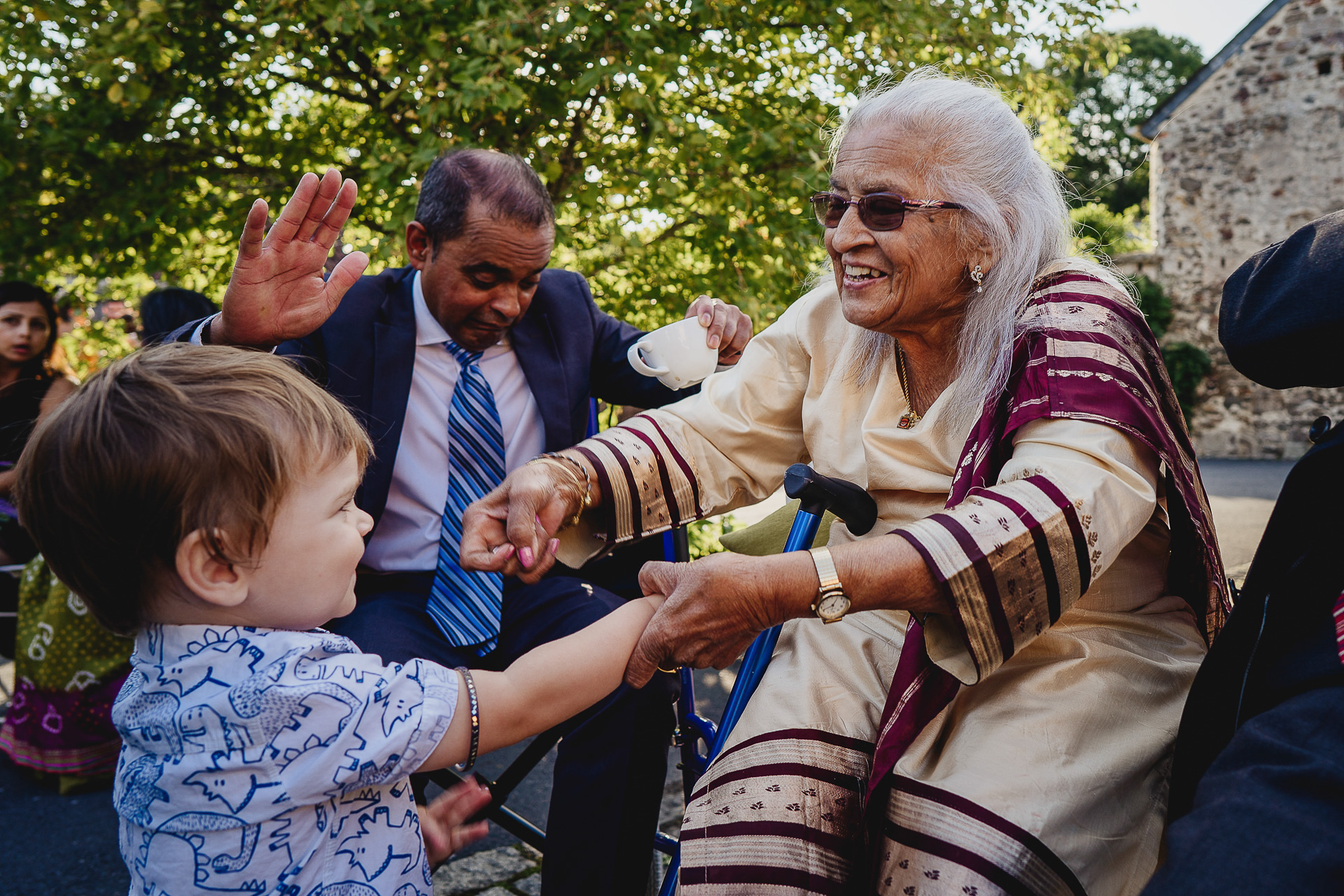 Older woman holding hands with young boy