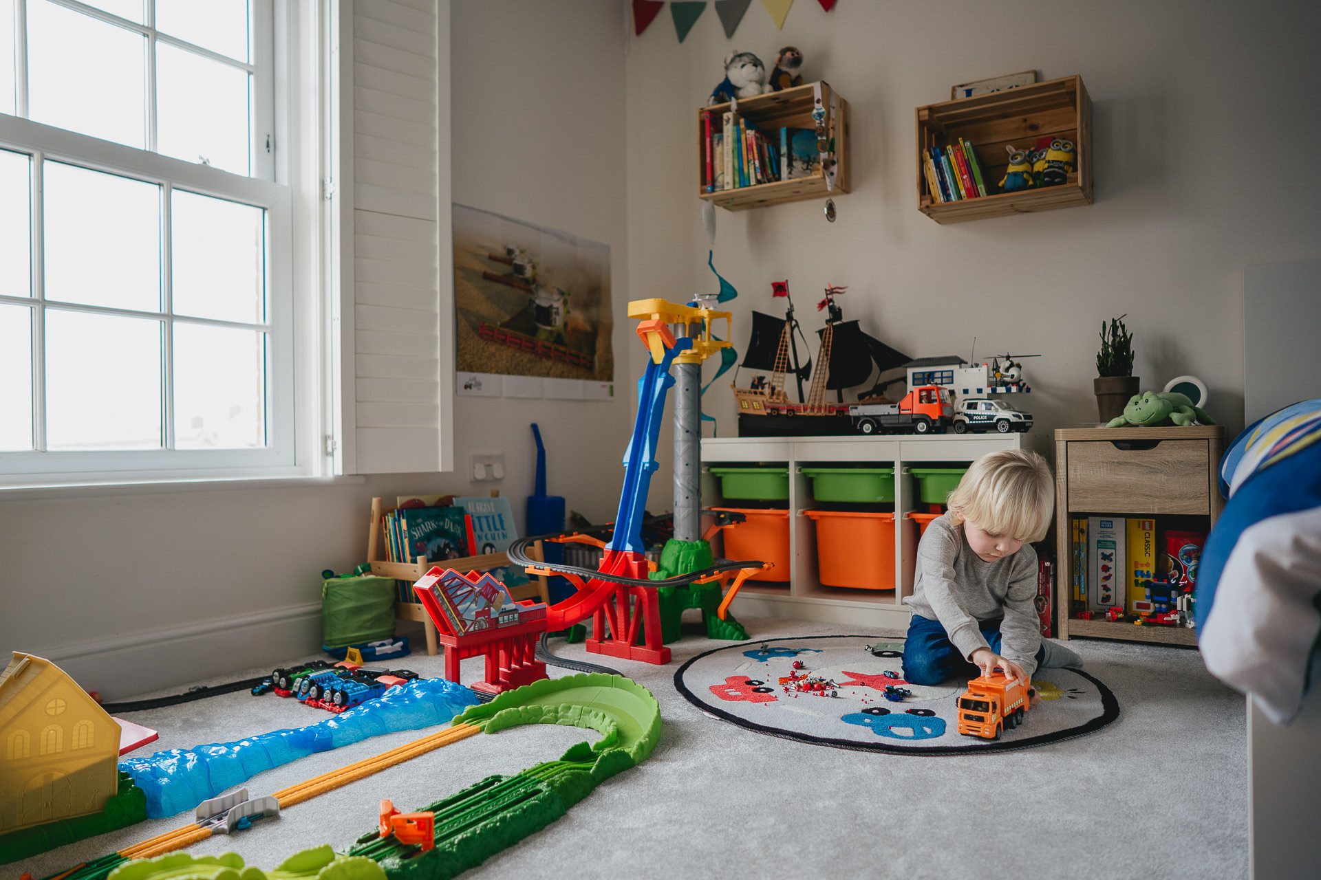 A small boy playing in his bedroom