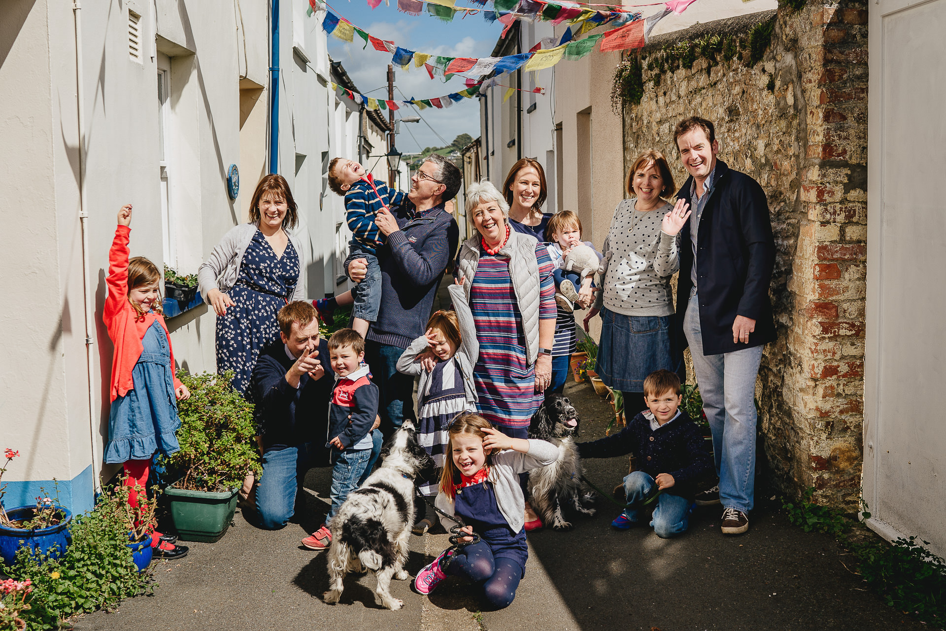 A relaxed family group photograph in a street covered by bunting