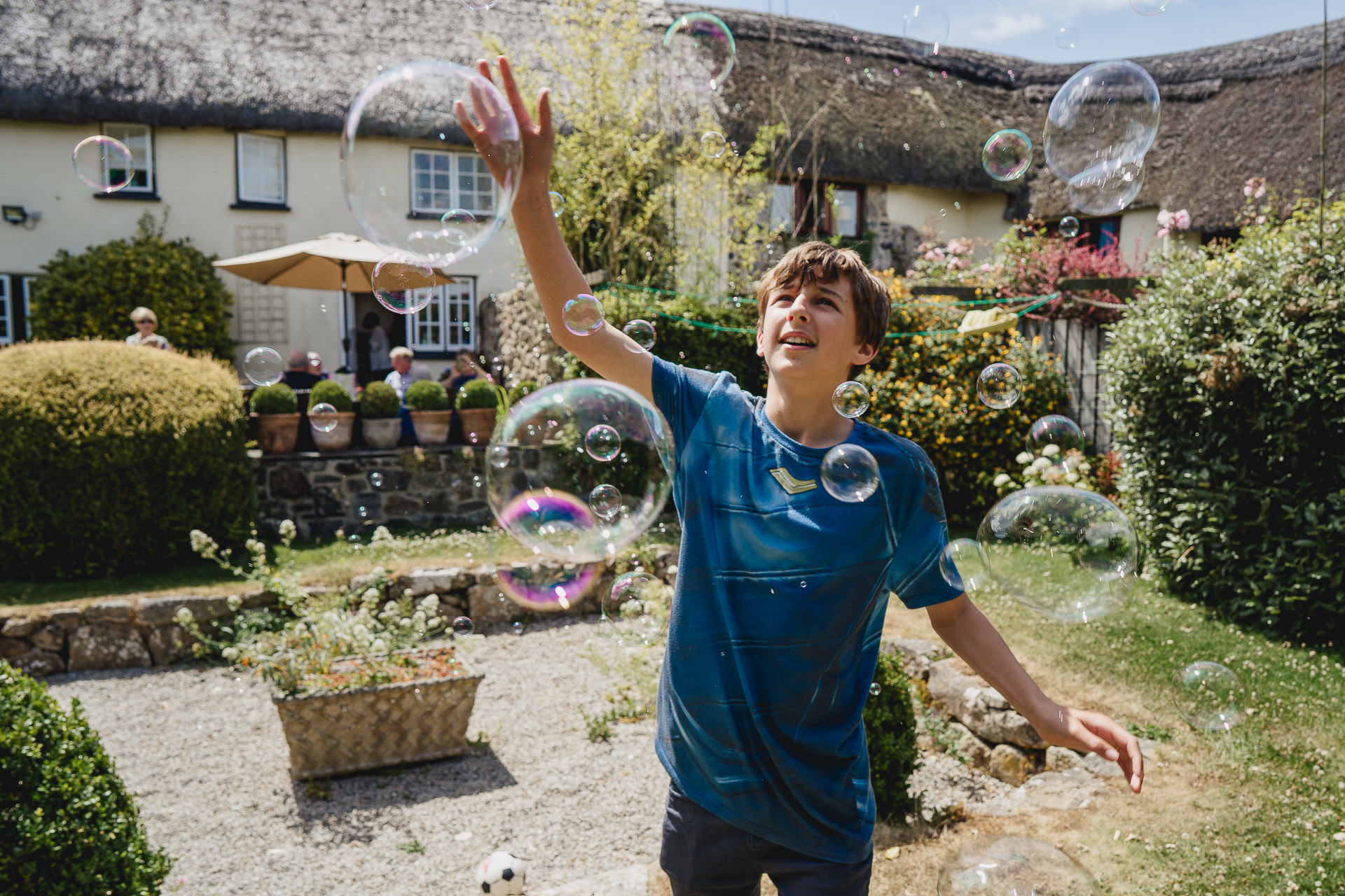 A teenage boy jumping amongst bubbles