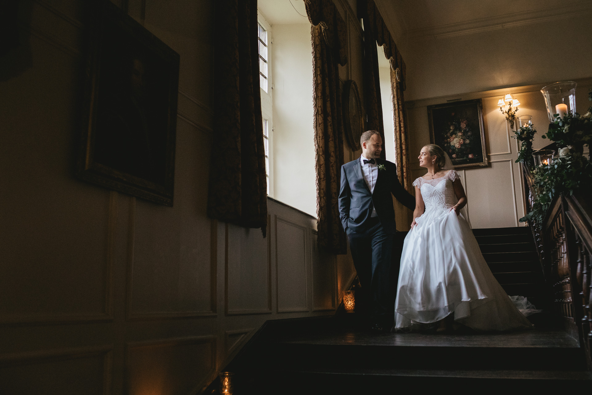 Bride and groom walking down a grand staircase