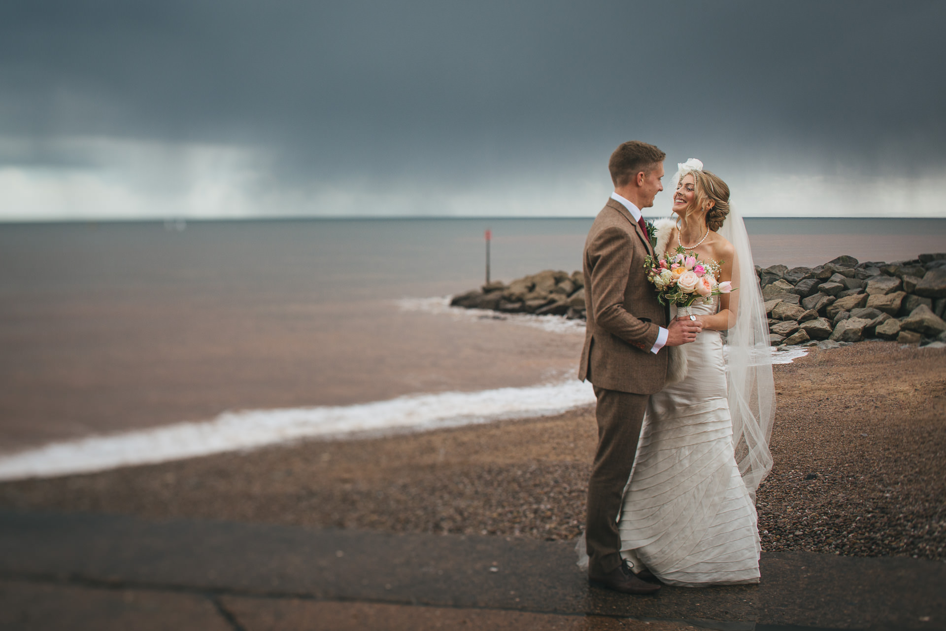 A bride and groom portrait when there is rain on your wedding day