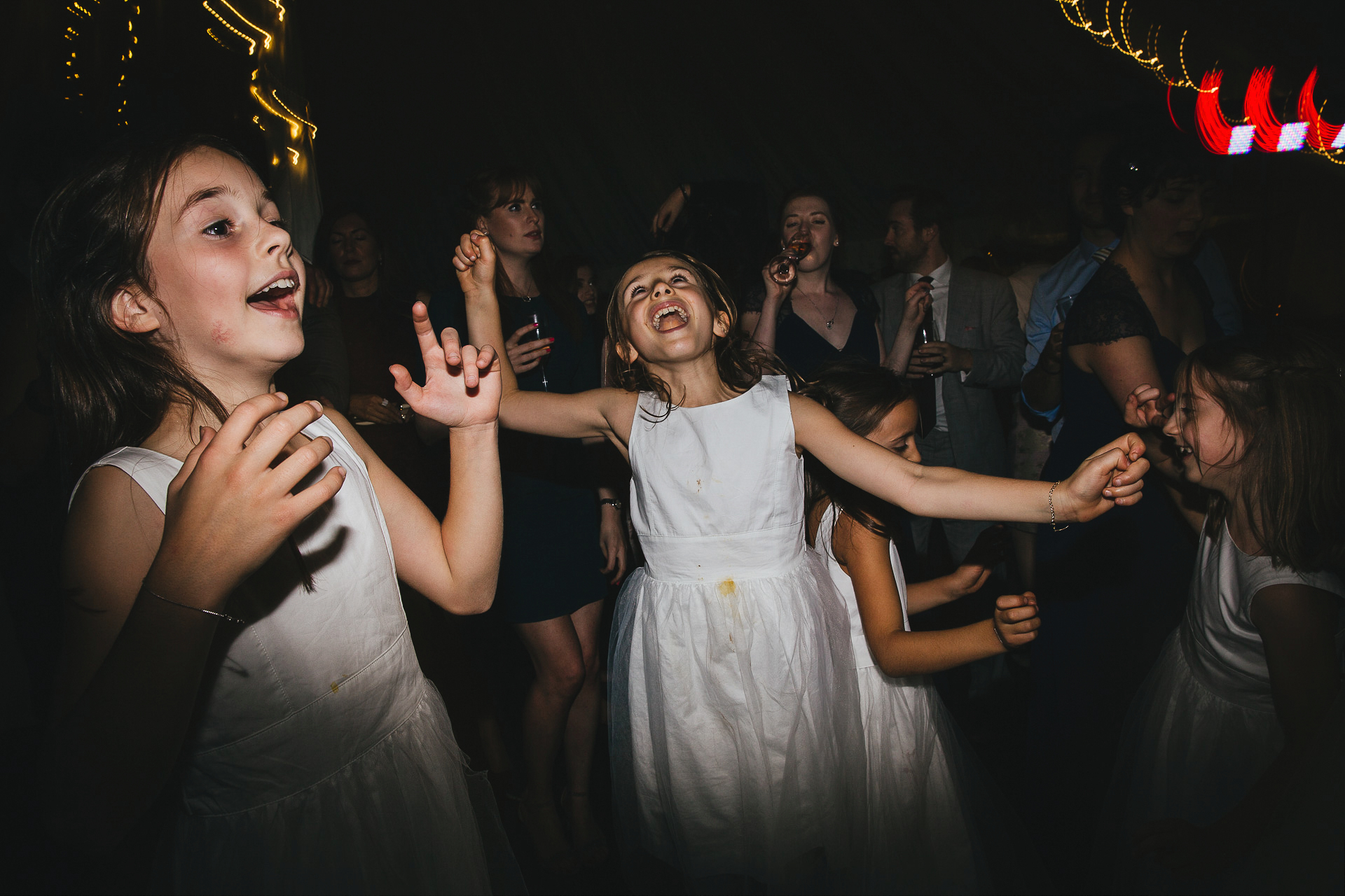 Flower girls in white dresses on the dance floor