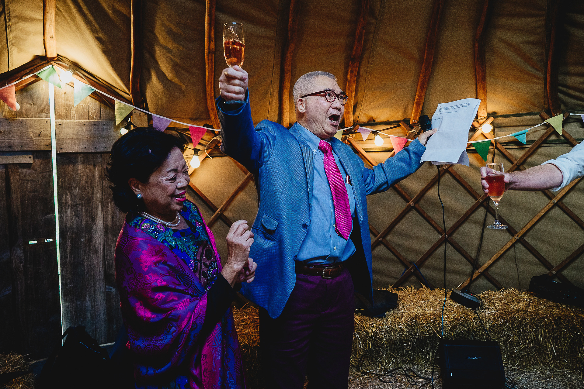 Father of the bride raising a joyful toast in a yurt