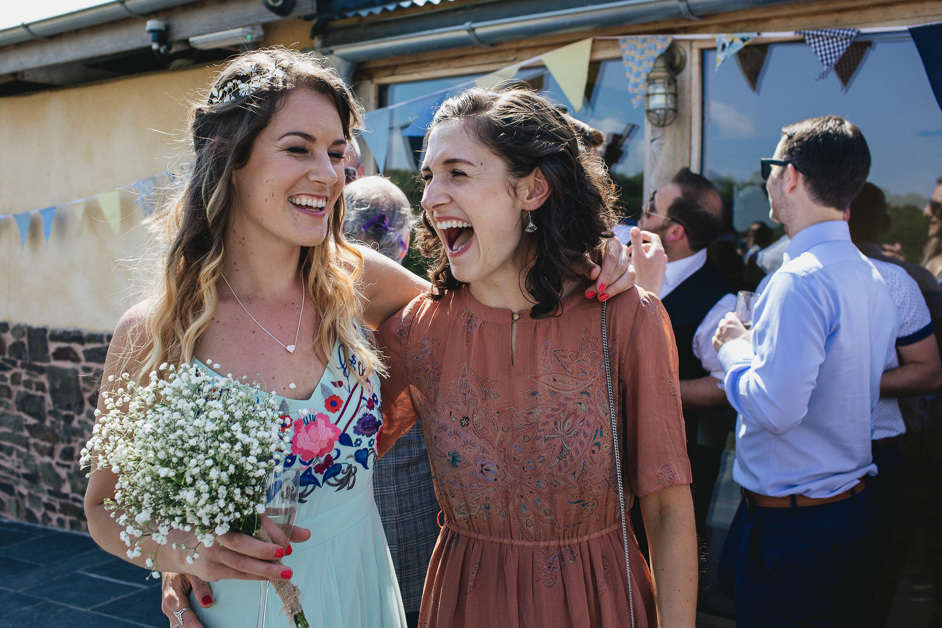 Bridesmaid and friend smiling together
