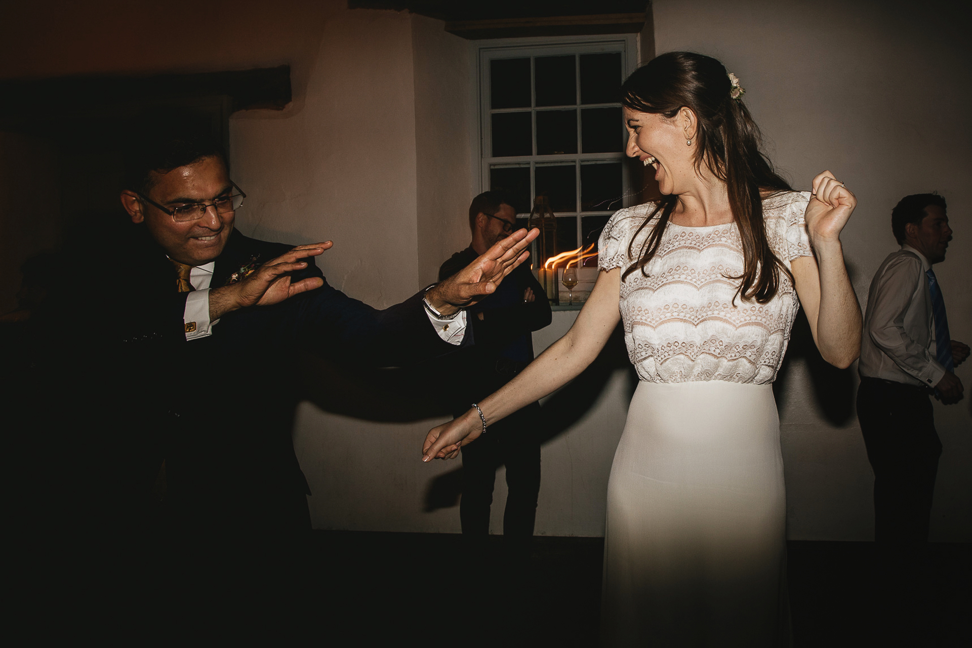 Bride dancing happily with wedding guests