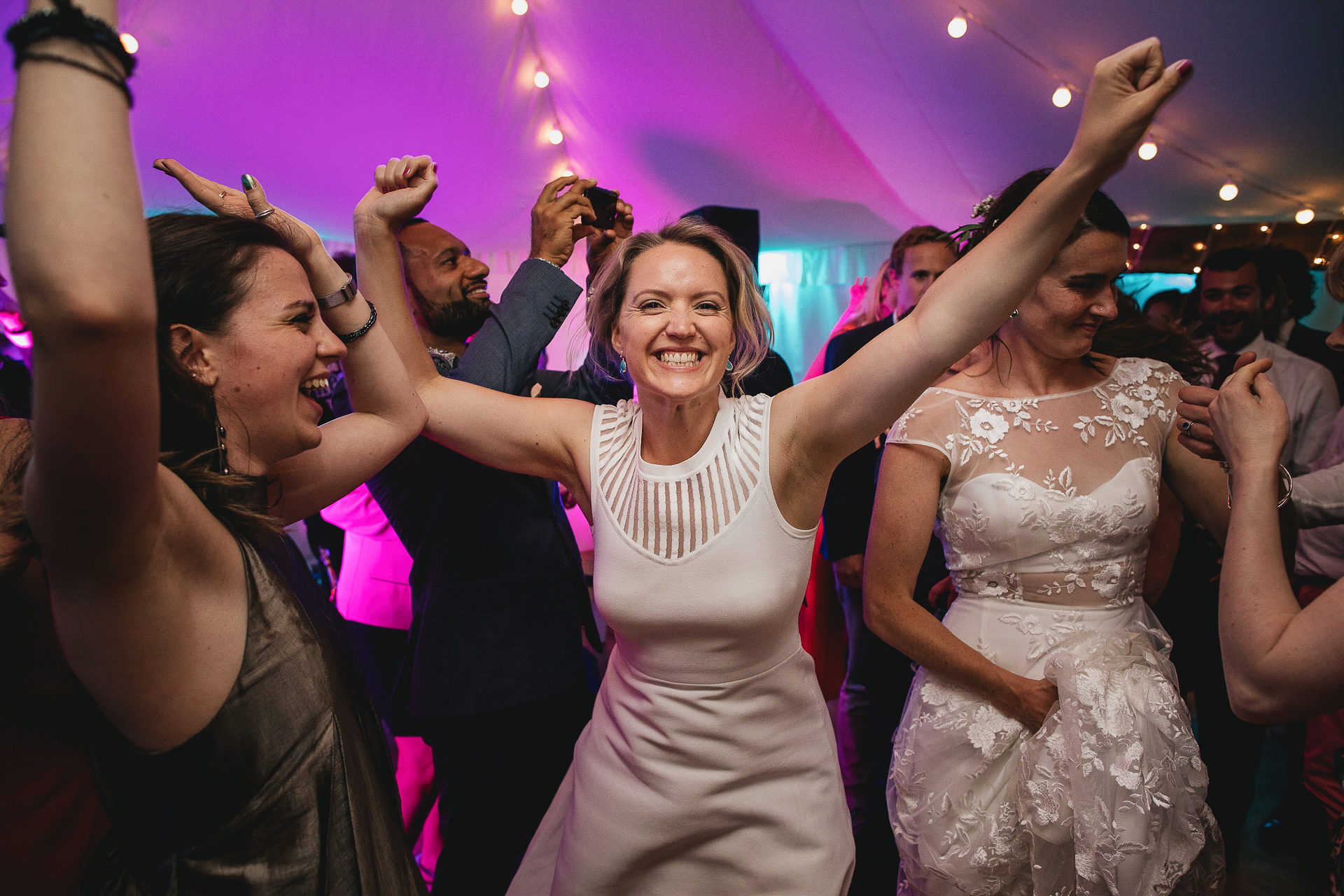 Joyful wedding guests on a dance floor