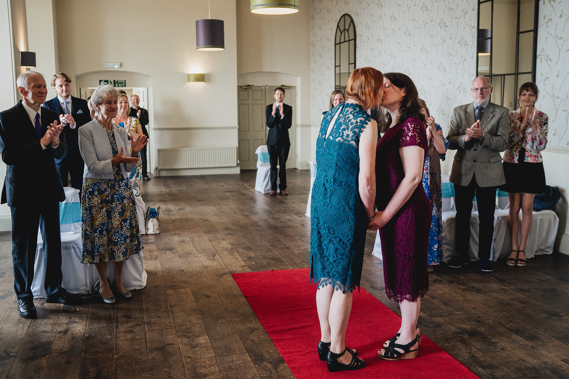 Bride and bride's first kiss during socially distanced ceremony