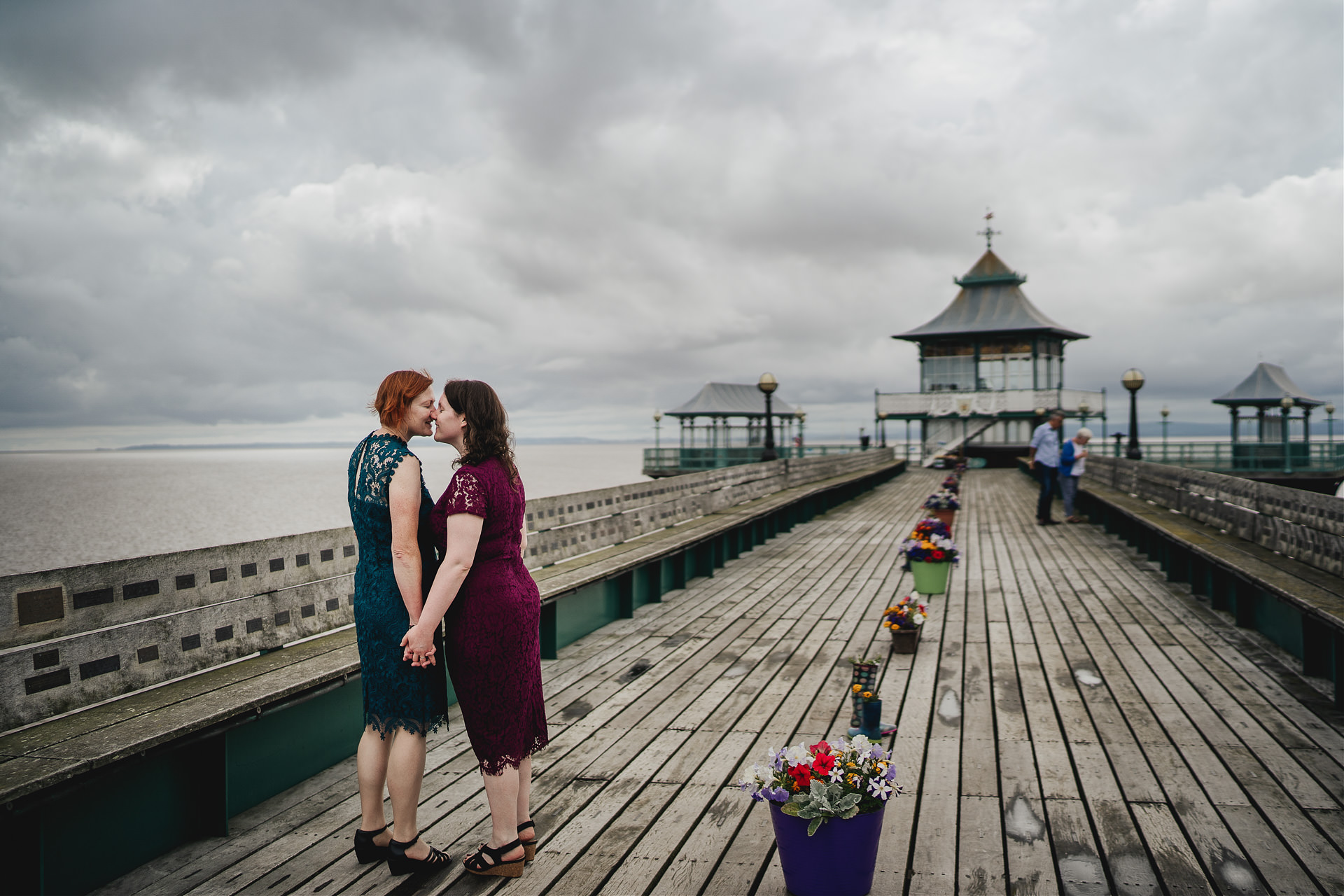 Two brides kissing on Clevedon pier