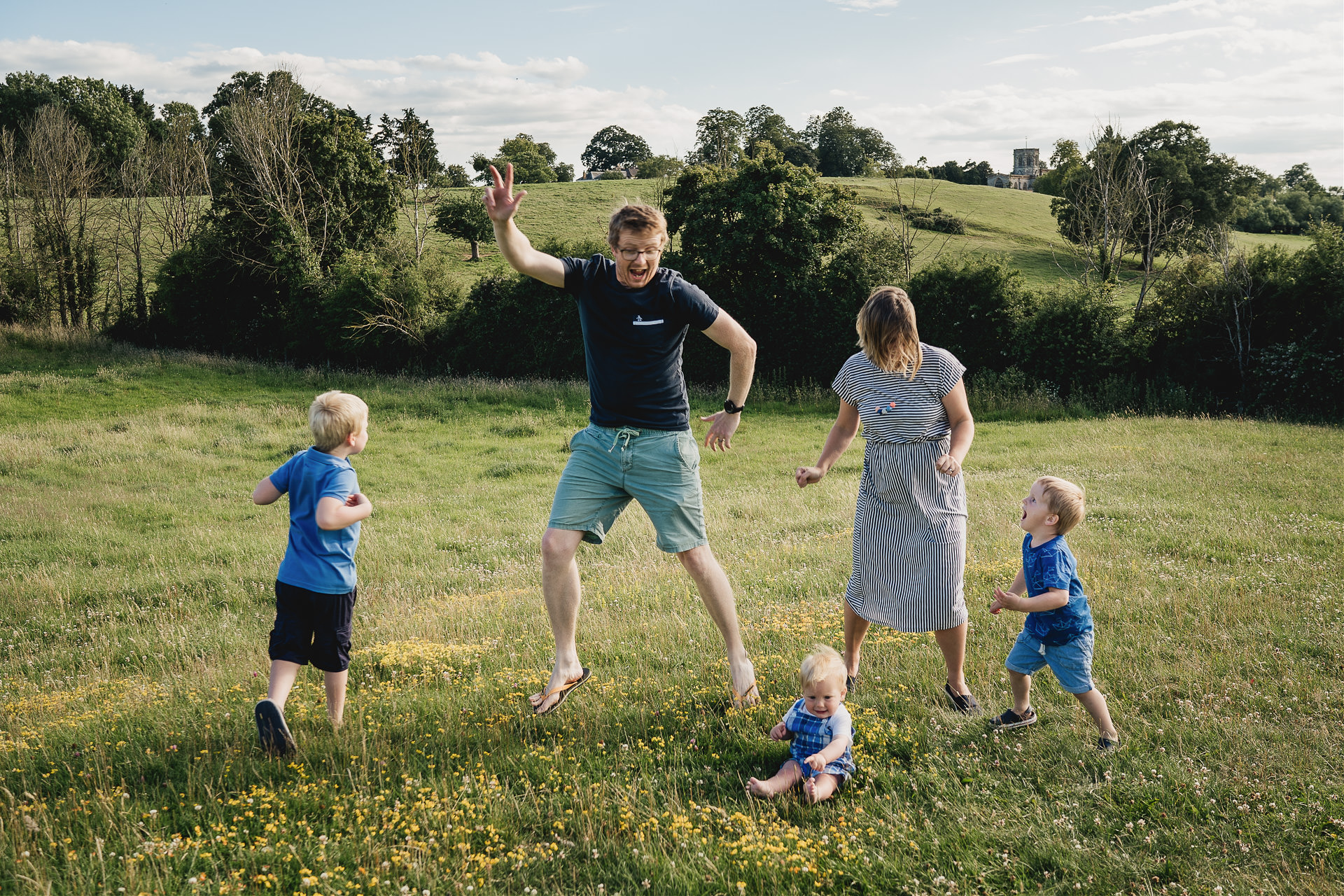 A family doing funny dancing on a hillside