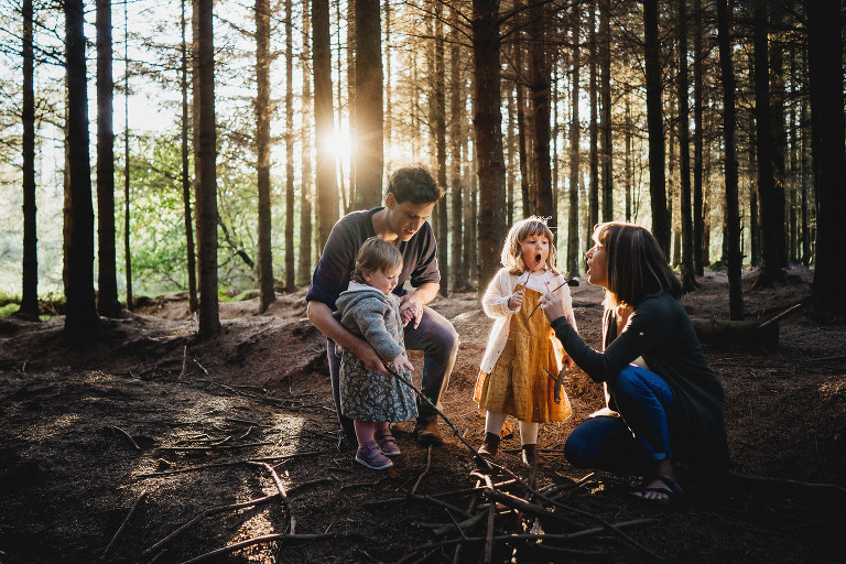 An evening family photography session in the woods with sunlight through the trees