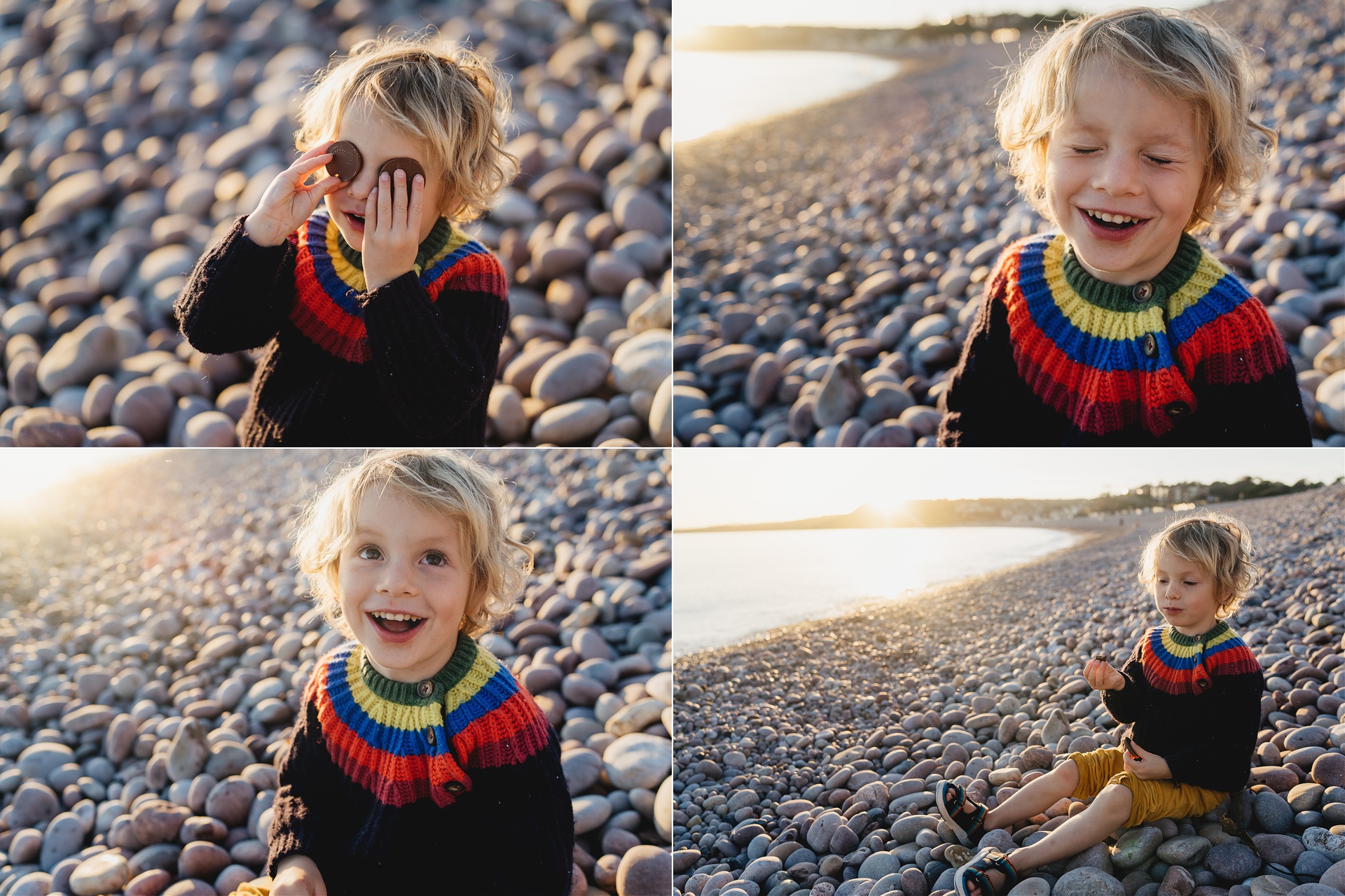 A small boy sitting on a beach and laughing