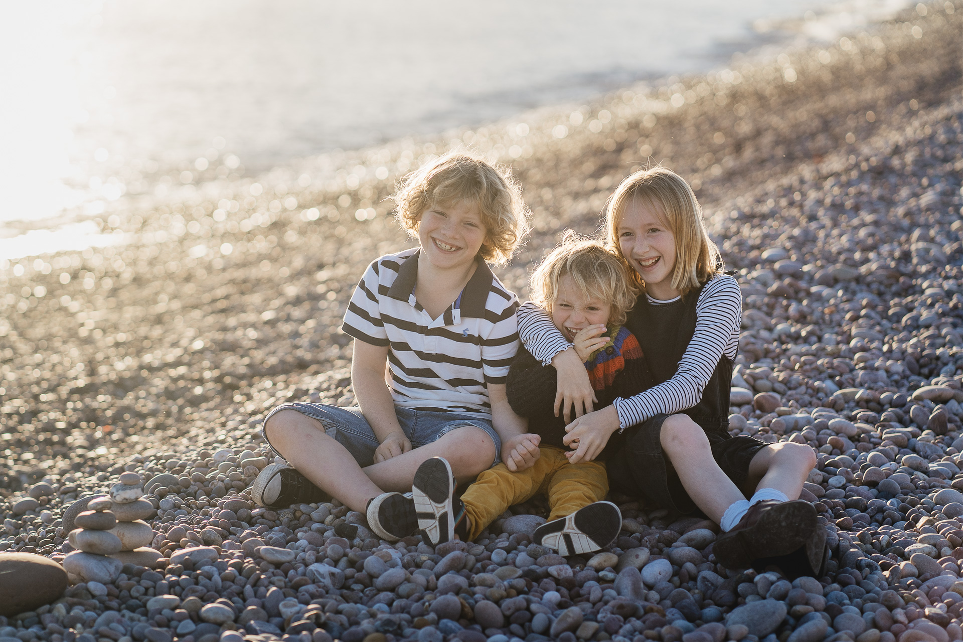 Sibling group photograph on a beach in the sunset