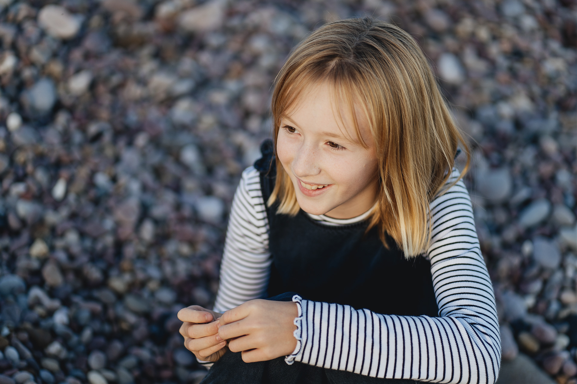 A young girl smiling on the beach