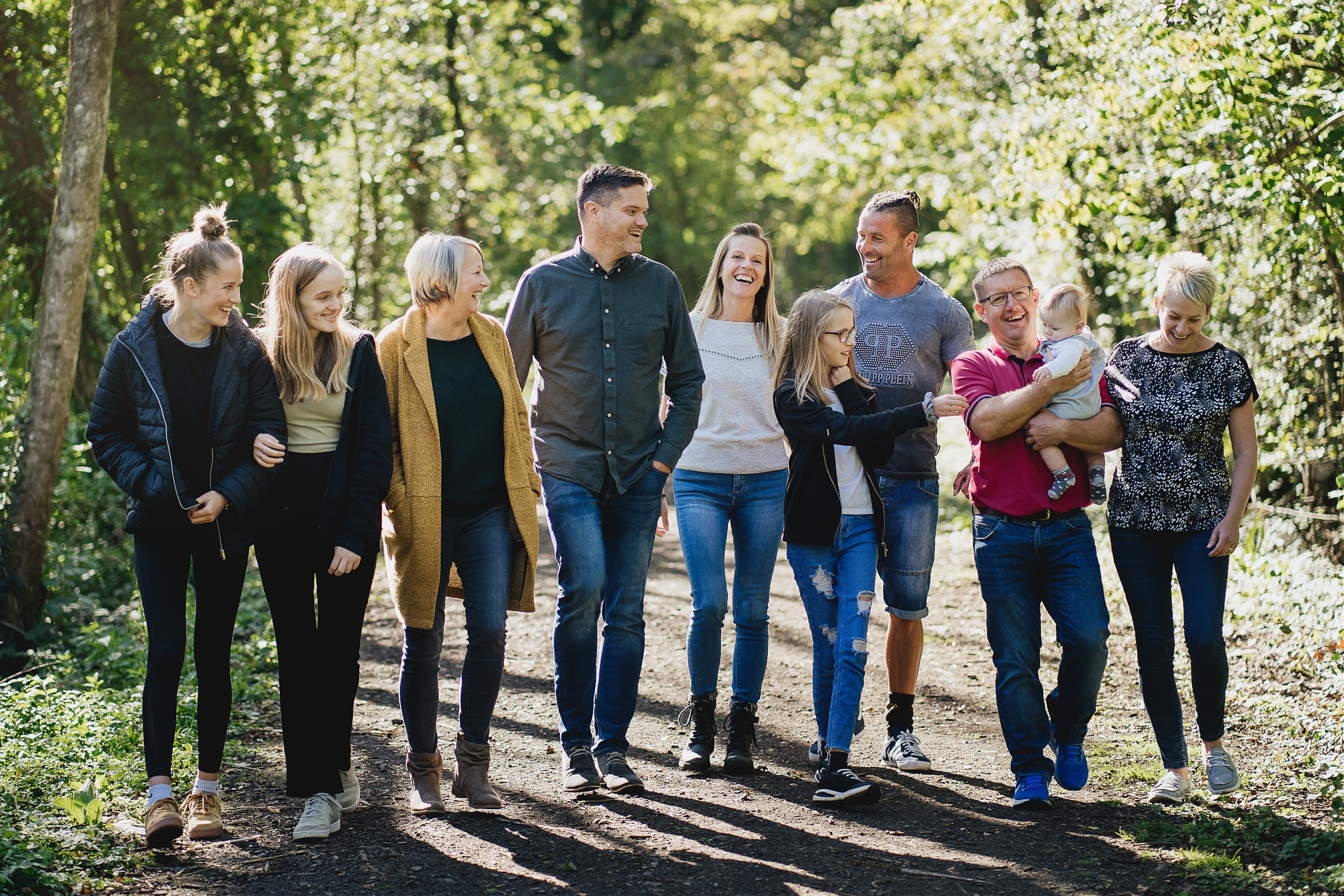 An extended family group photograph, walking and laughing together