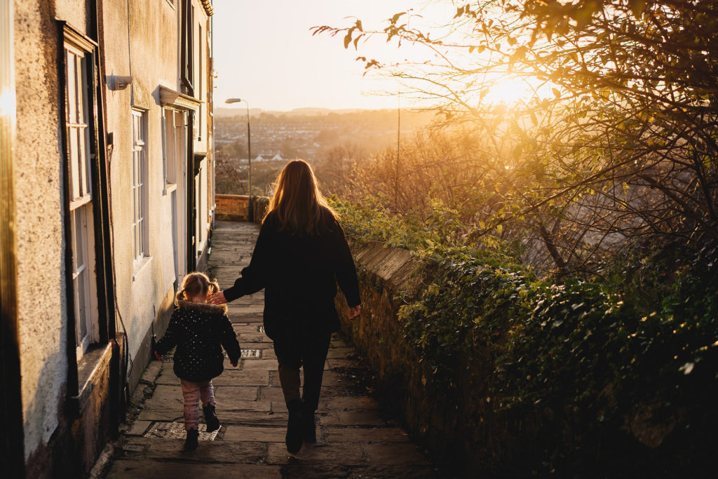 Two sisters walking together in evening light