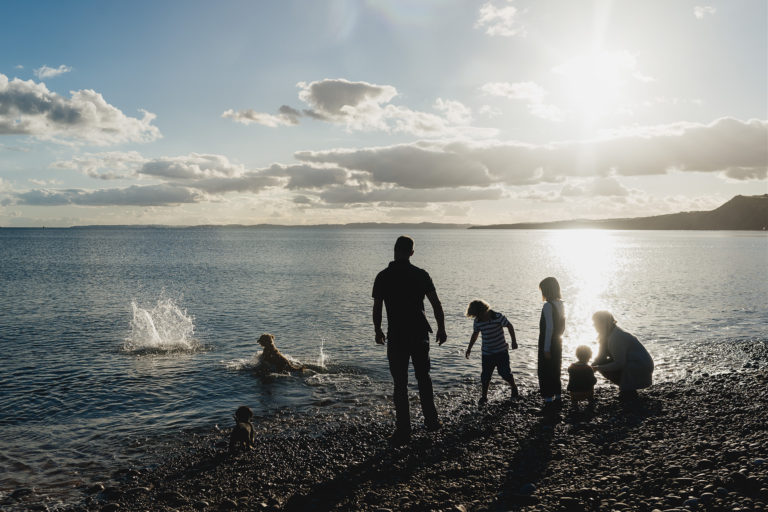A documentary portrait of a family playing together by the sea
