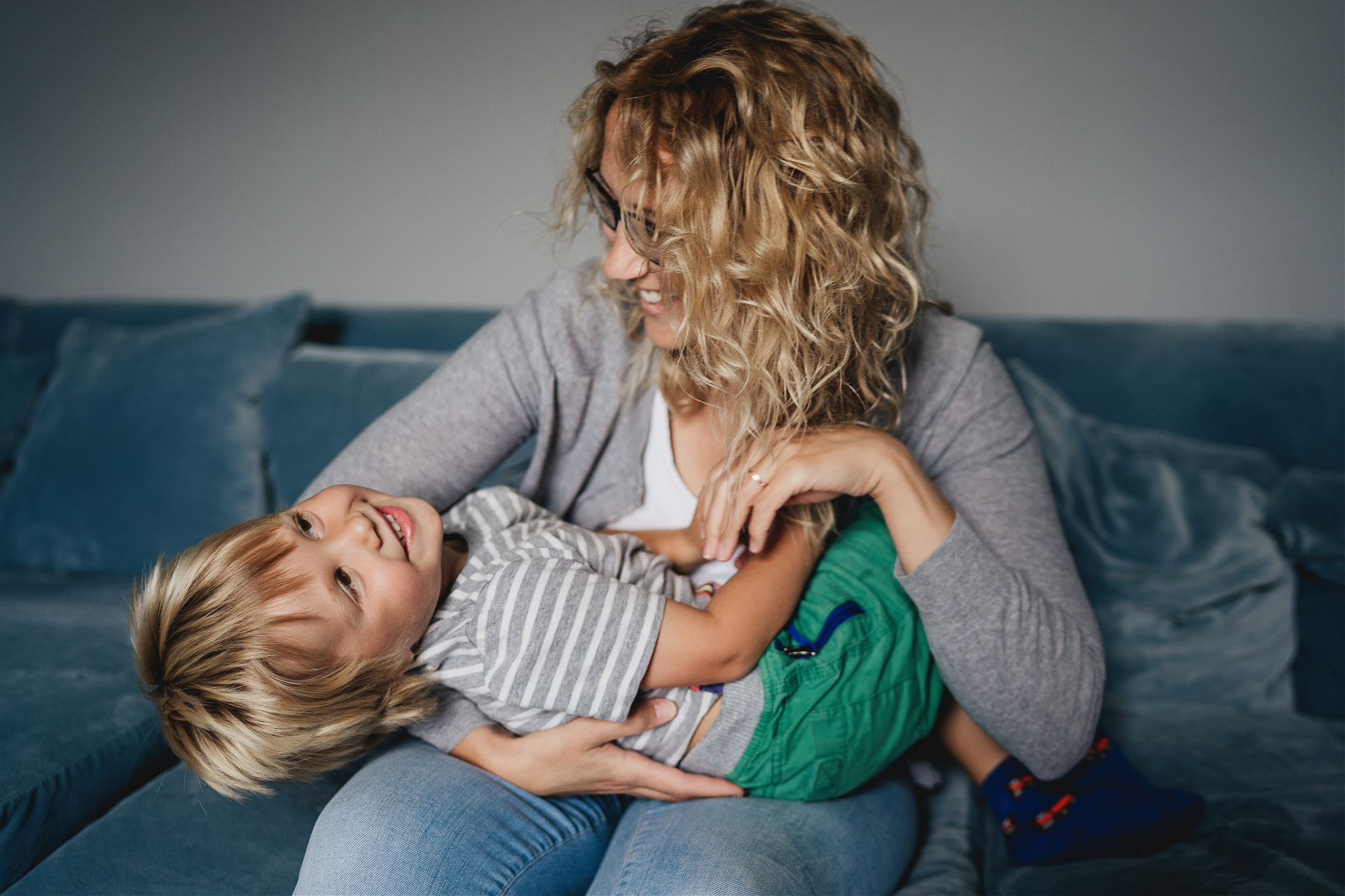 Relaxed Devon family photography of a mother tickling and cuddling her young son