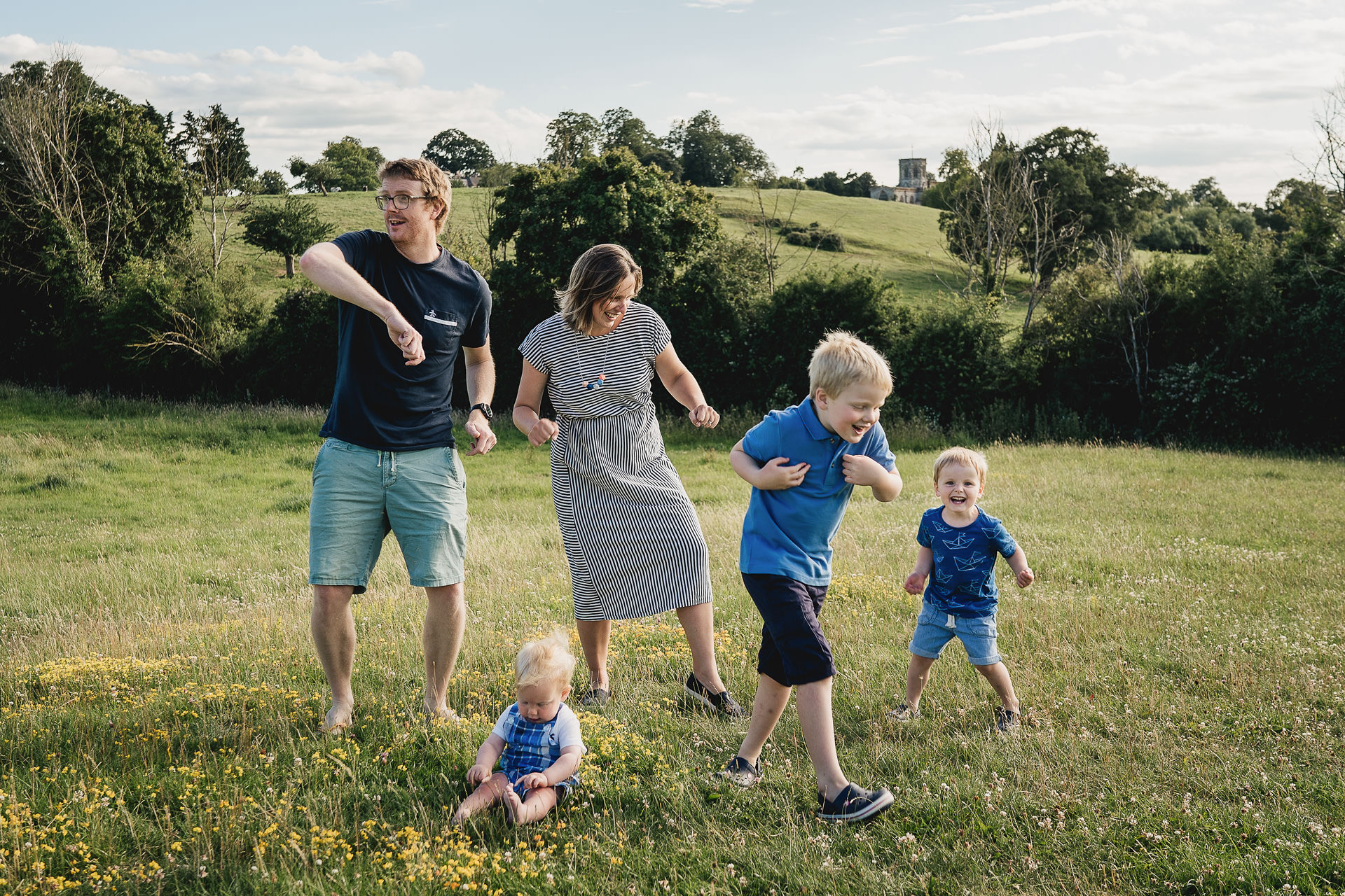 A family dancing together in a field