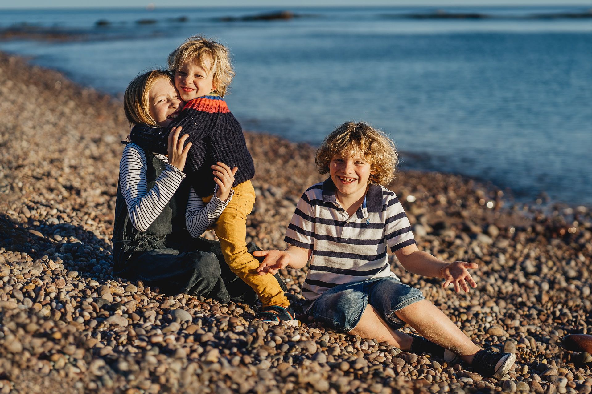 Best Devon family photography group photo of three children on a beach