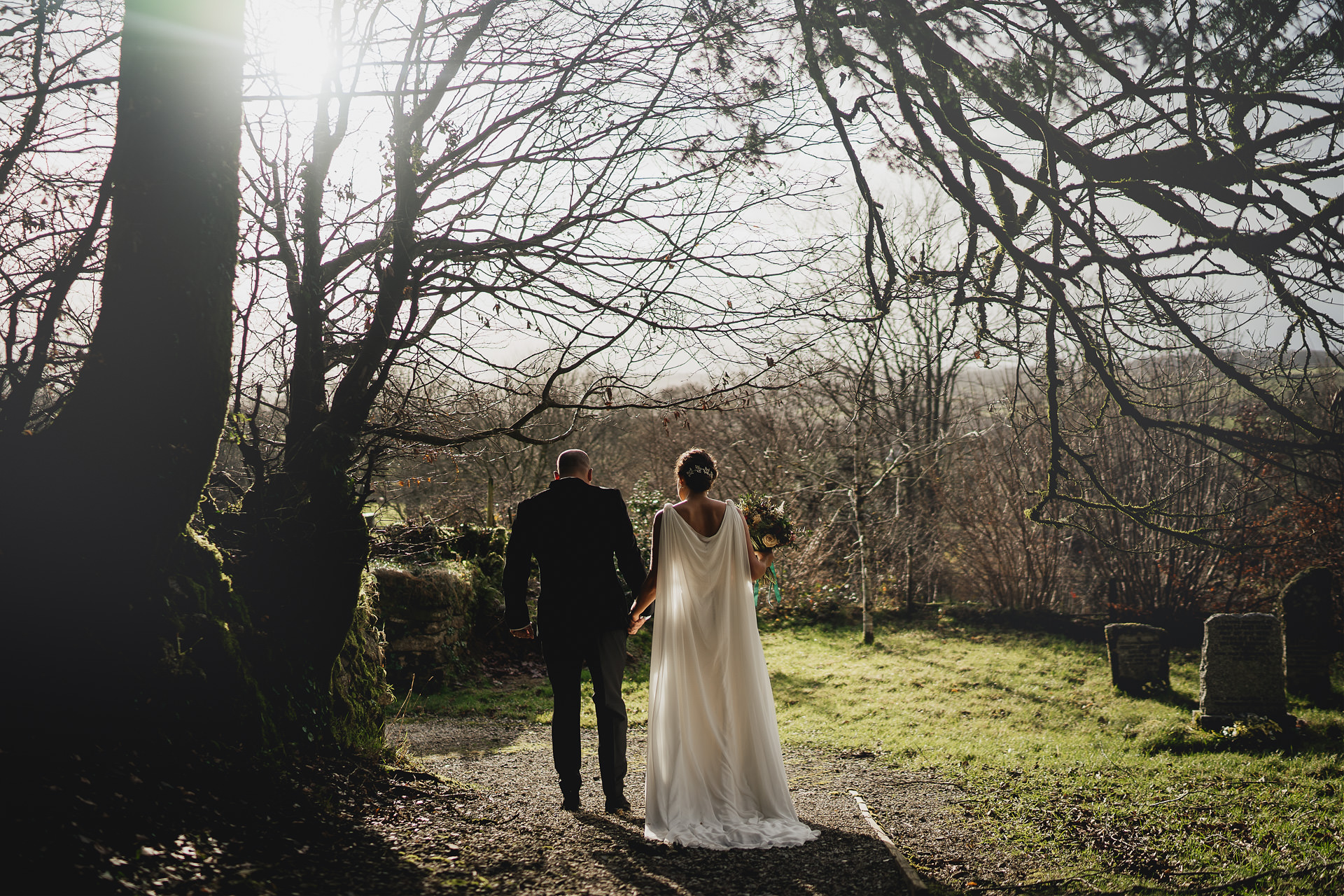 A bride and groom walking in soft sunlight