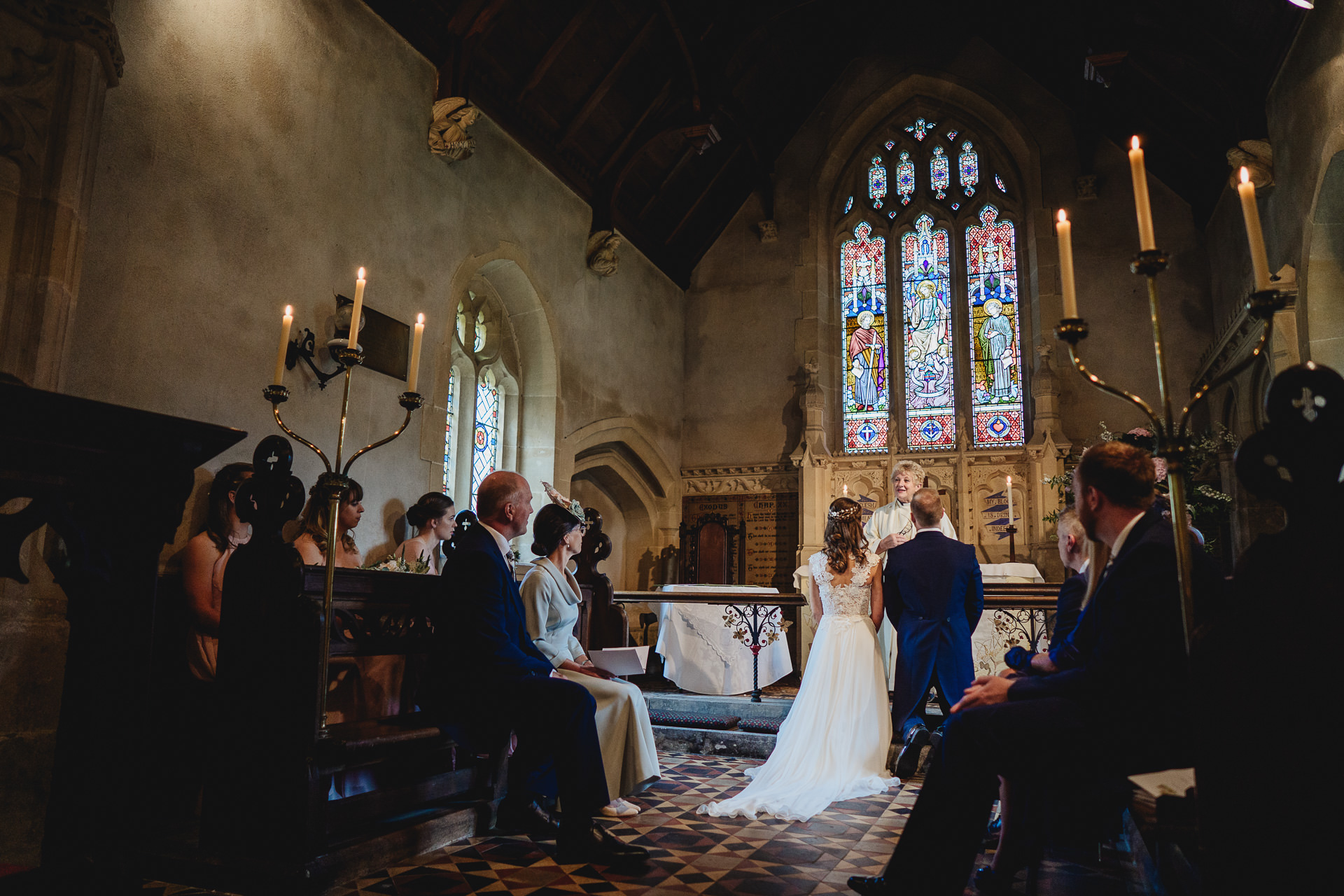 Bride and groom kneeling to pray in a church