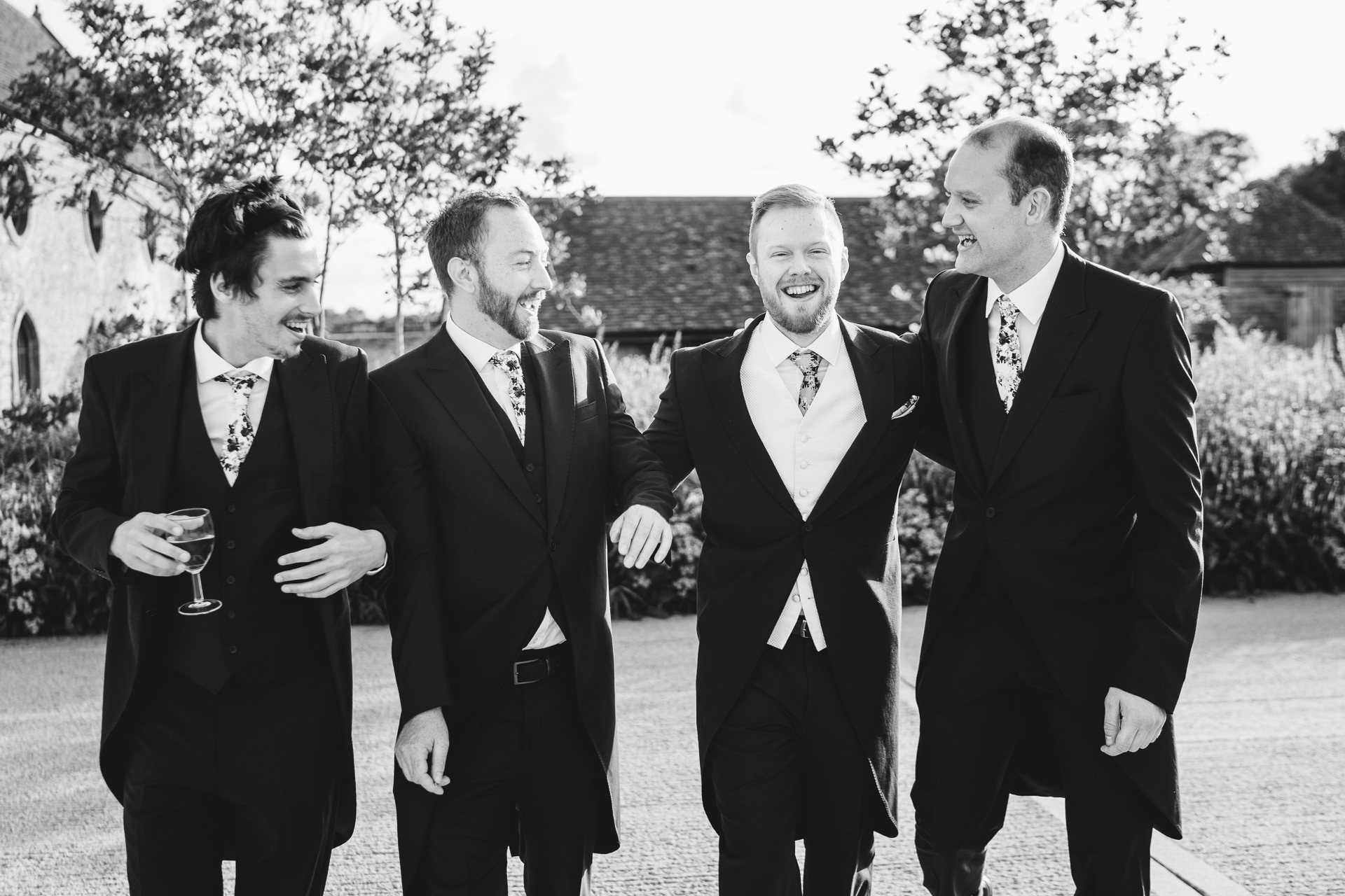 Groom with groomsmen laughing together