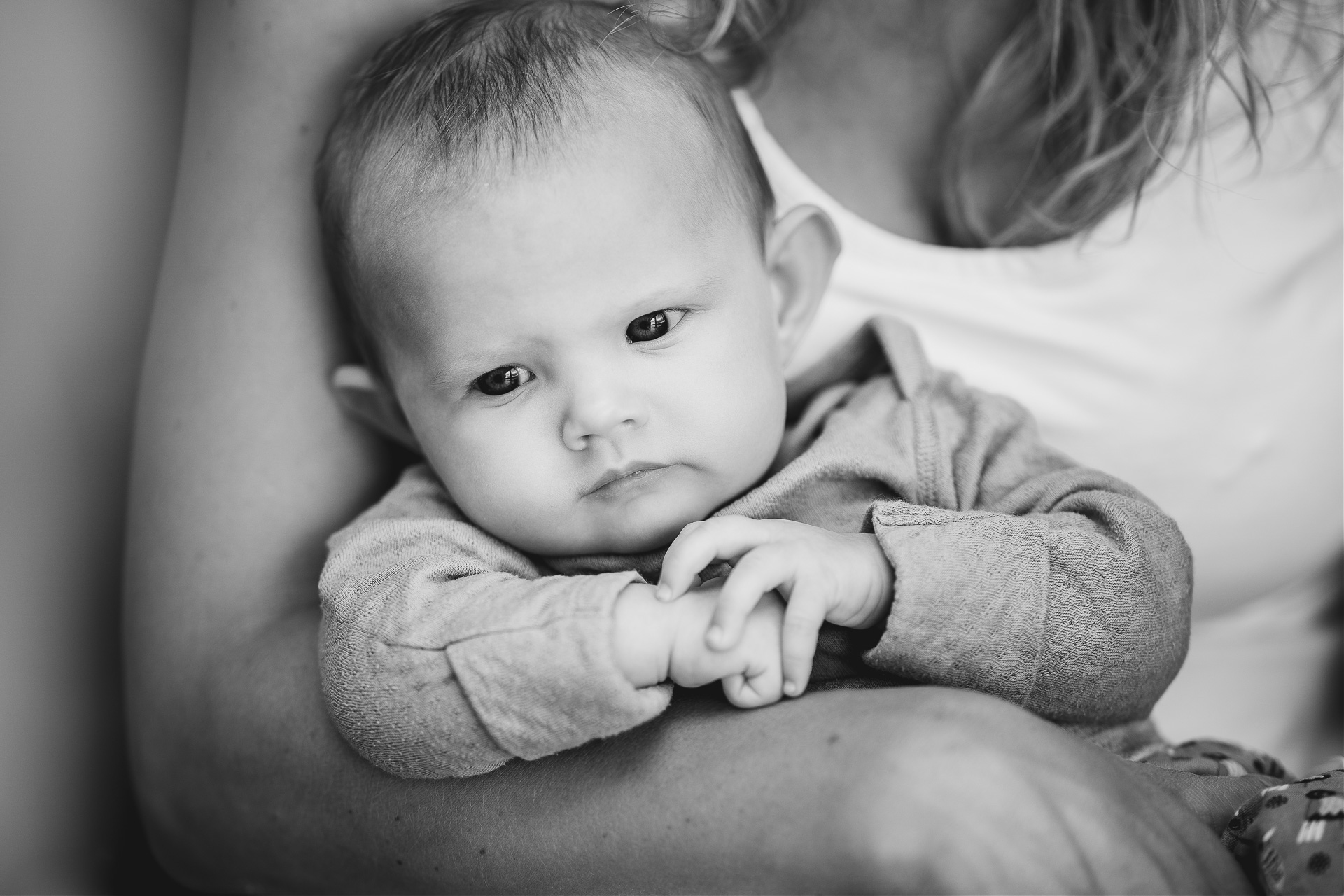 Family photography at home, a baby in her mother's arms