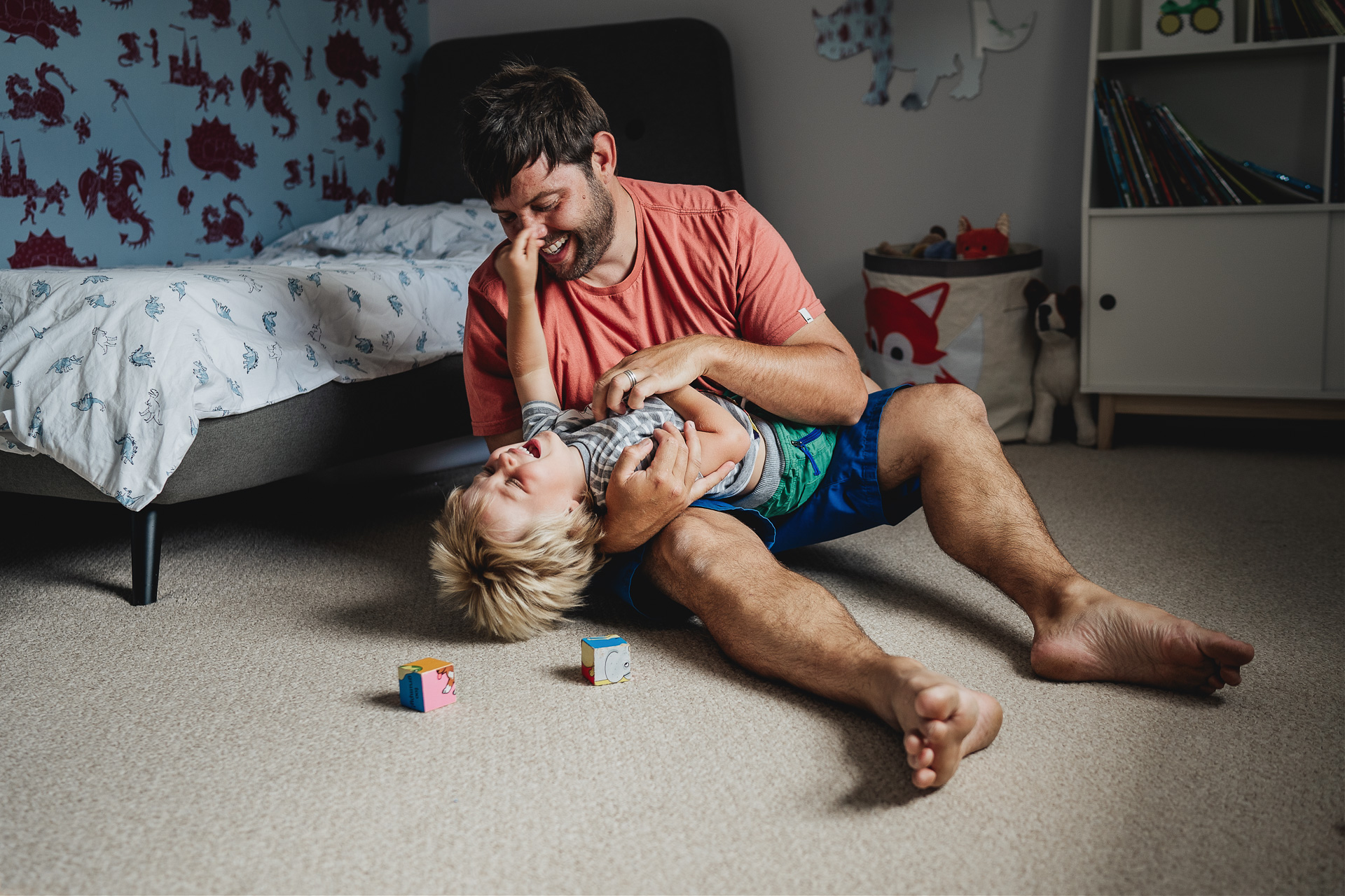 Family photography at home, a father and son playing in a bedroom